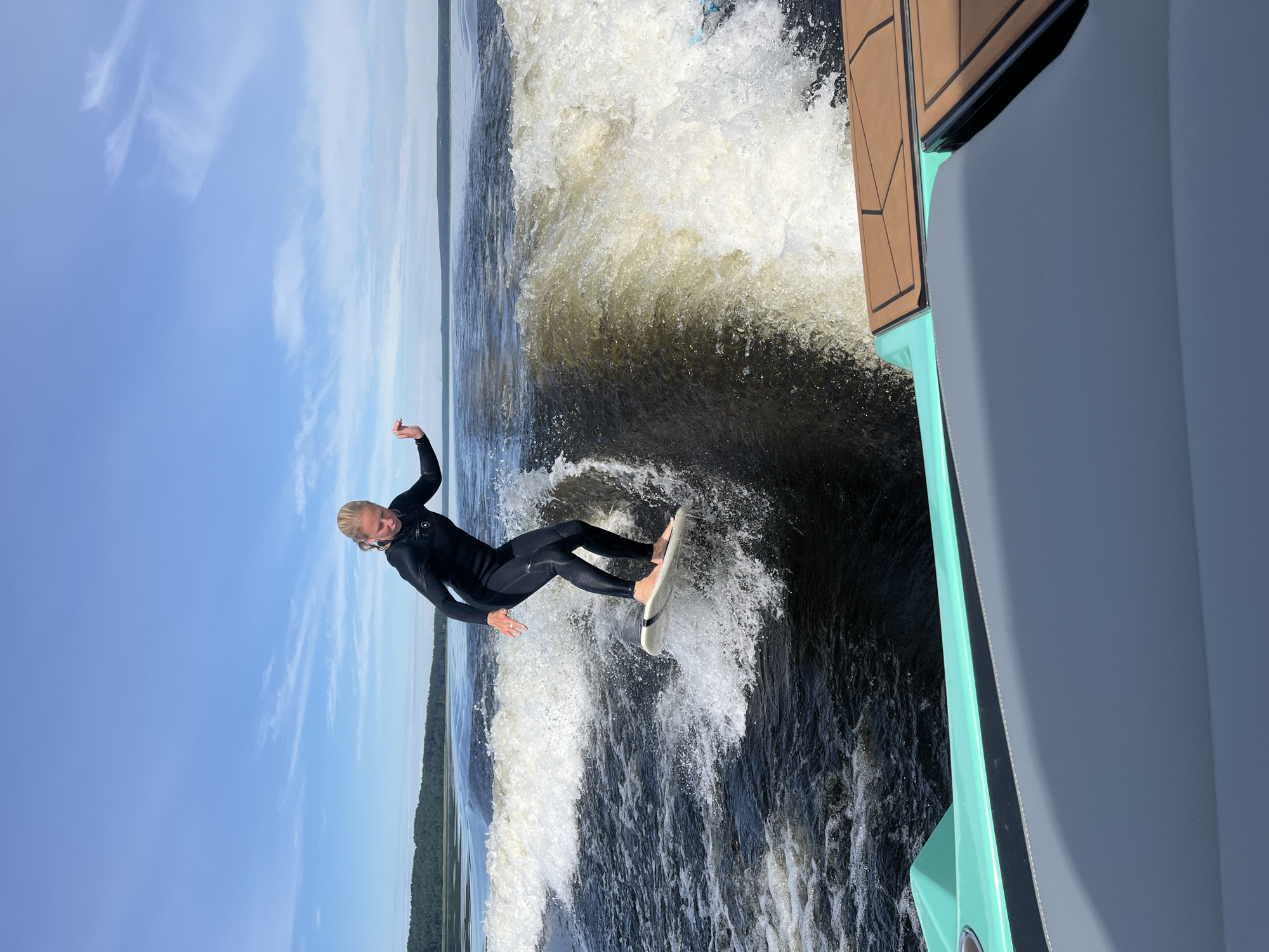 Wake surfing a boat wave on a Russian lake