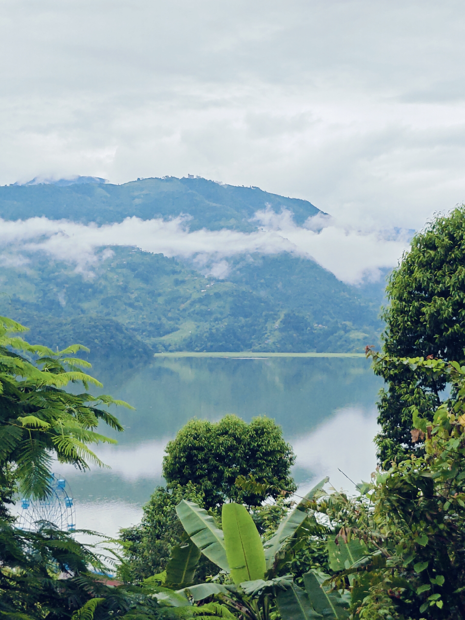 Pokhara's Phewa Lake and lakeside city under cloudy skies