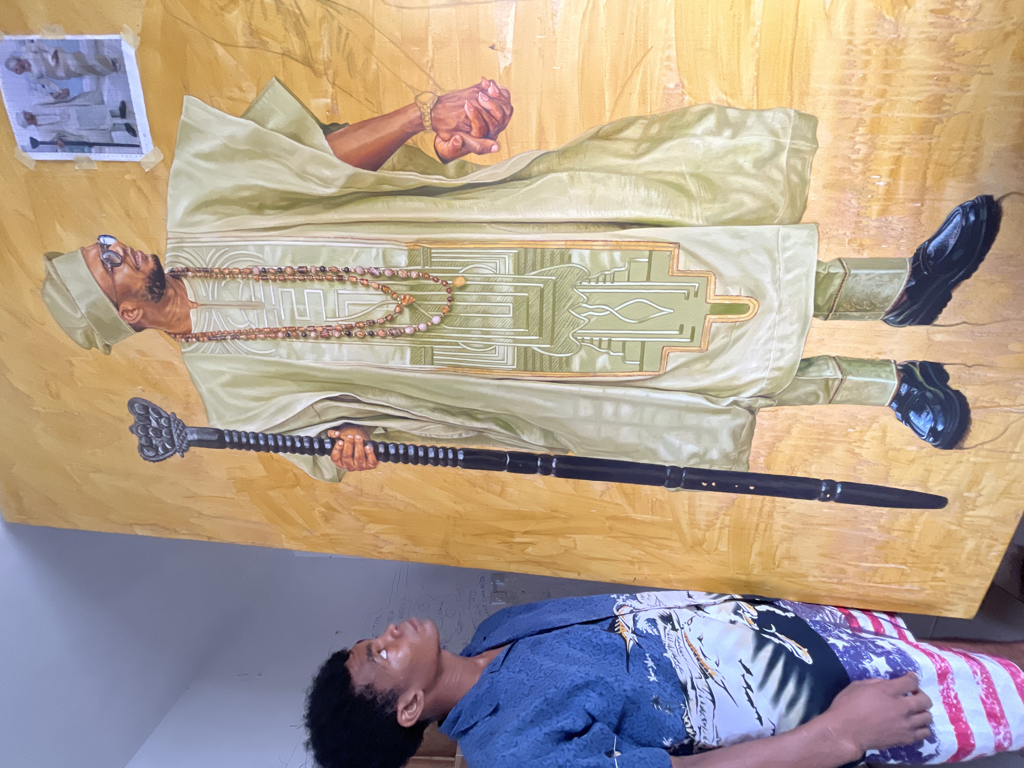 Inside a Nigerian artist's studio, paintings of cultural figures in progress