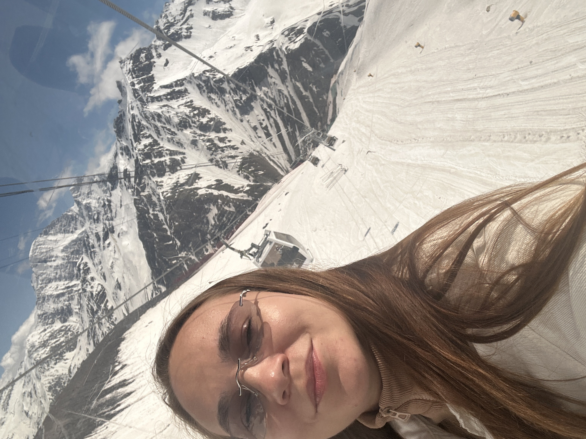 Cable car ascent through snowy mountains in Terskol