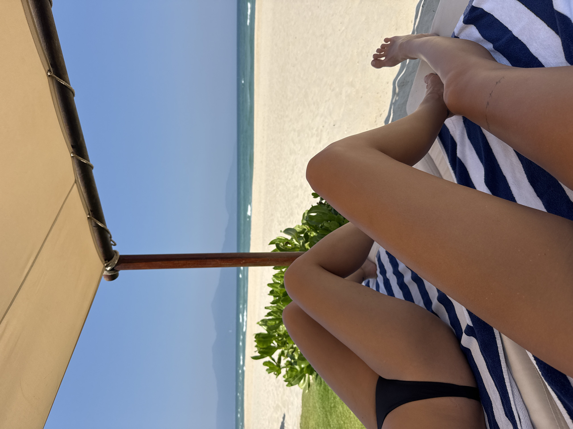 Woman relaxes on beach in Đà Nẵng, Vietnam morning