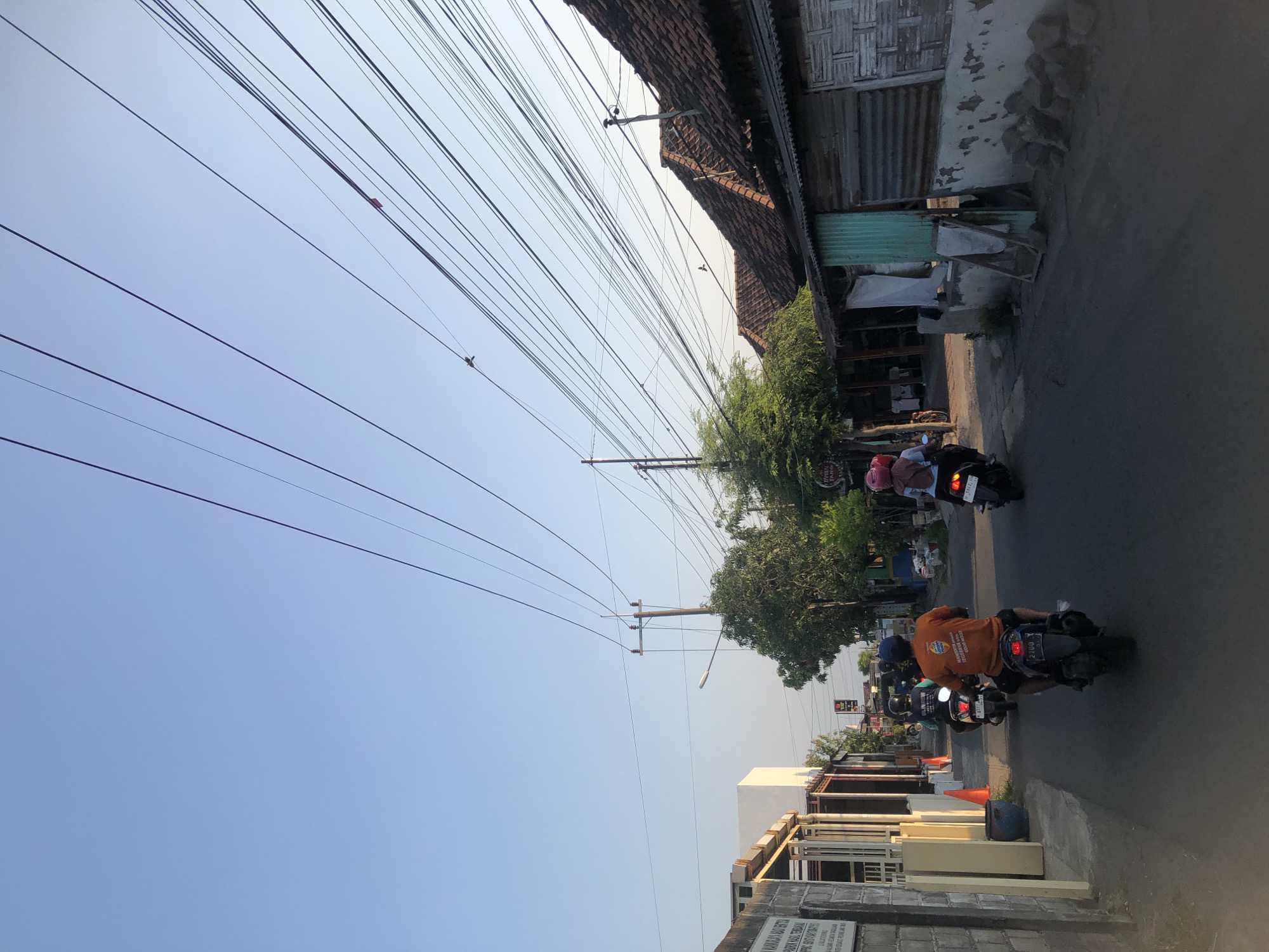 Morning street life across two Indonesian neighborhoods, July 2026
