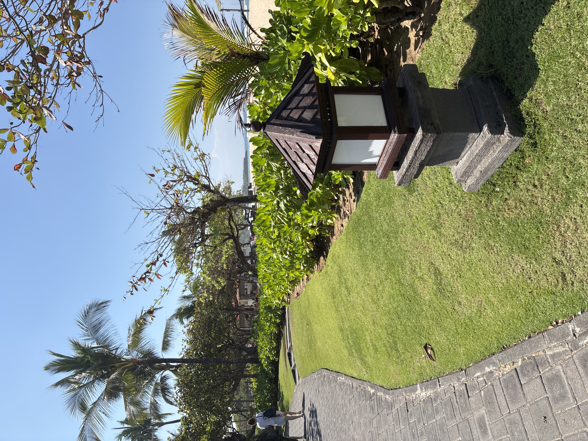 Bali resort grounds and beach on a clear tropical morning