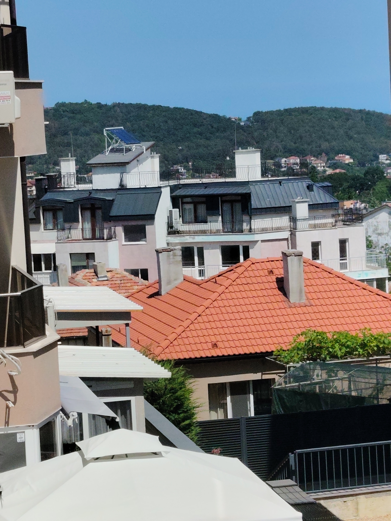Red-roofed neighborhood and art supplies, same afternoon