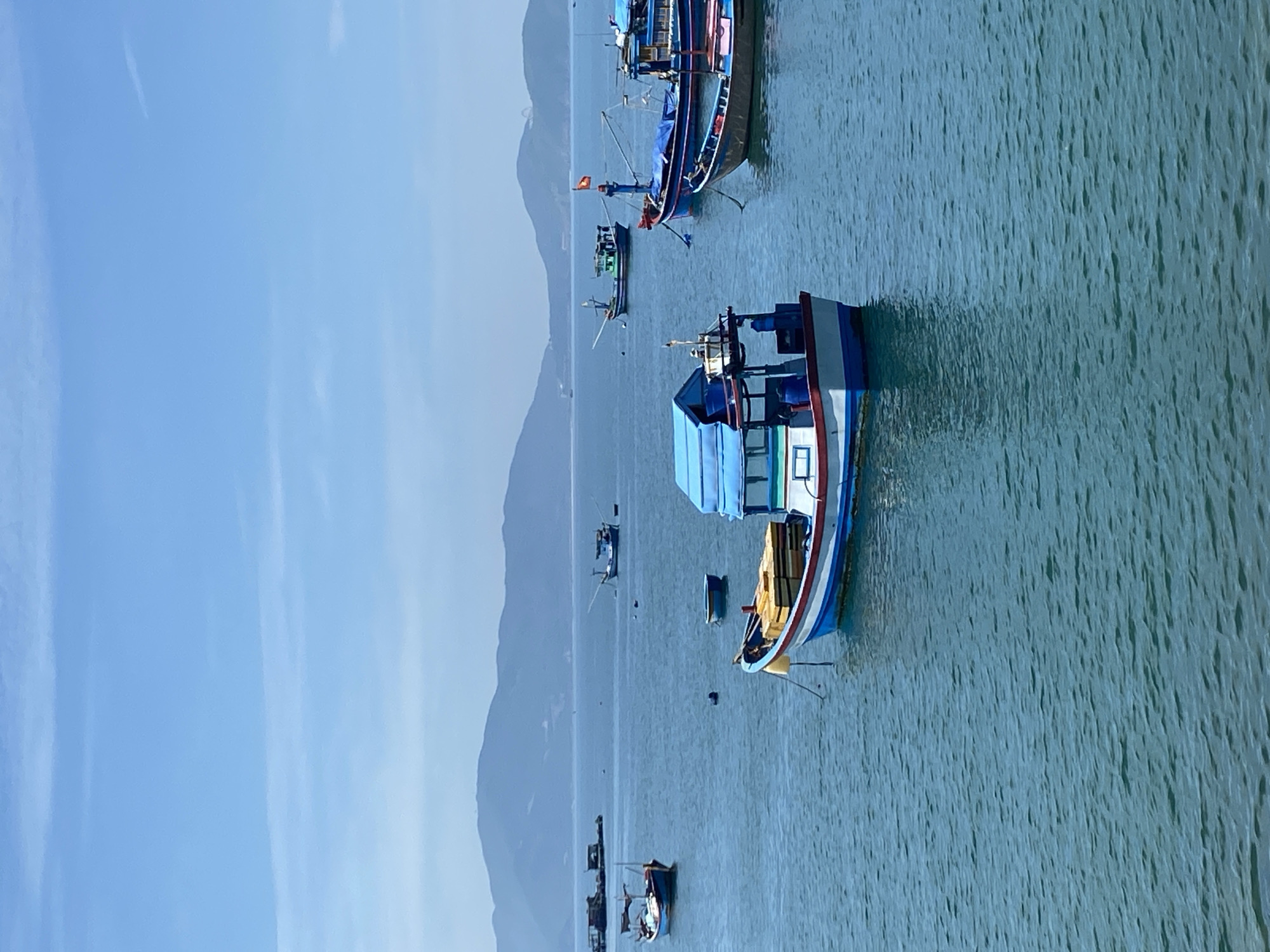Nha Trang harbor on a calm morning, boats and shoreline