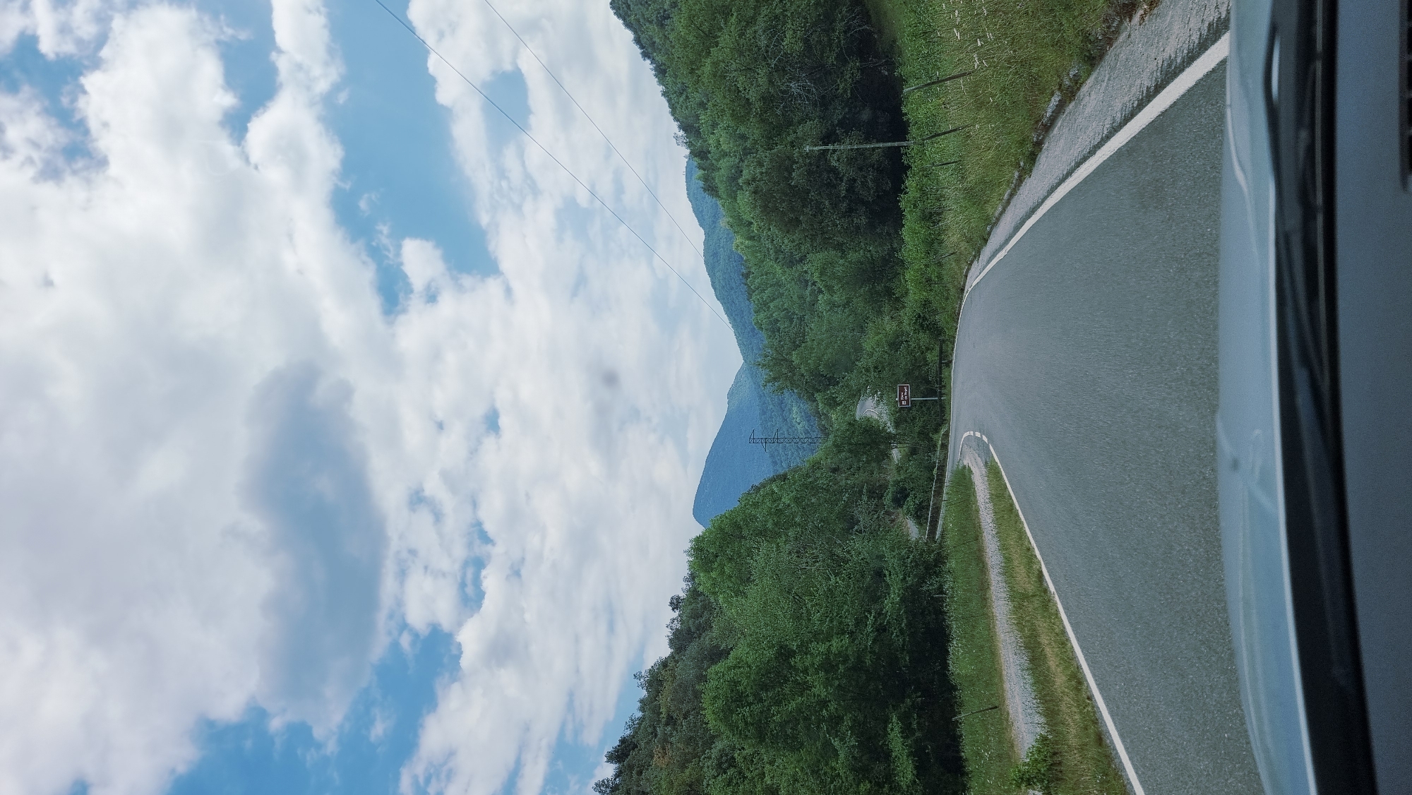 Winding mountain road through green hills near Camprodon