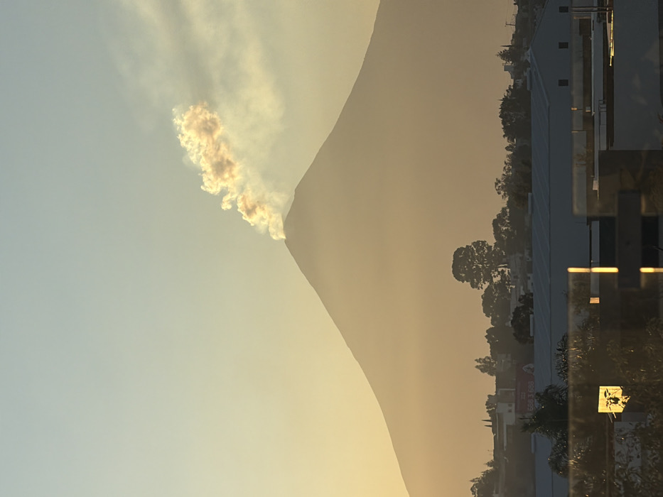 Volcano emits smoke plumes during sunset near Tlaxcalancingo, Mexico