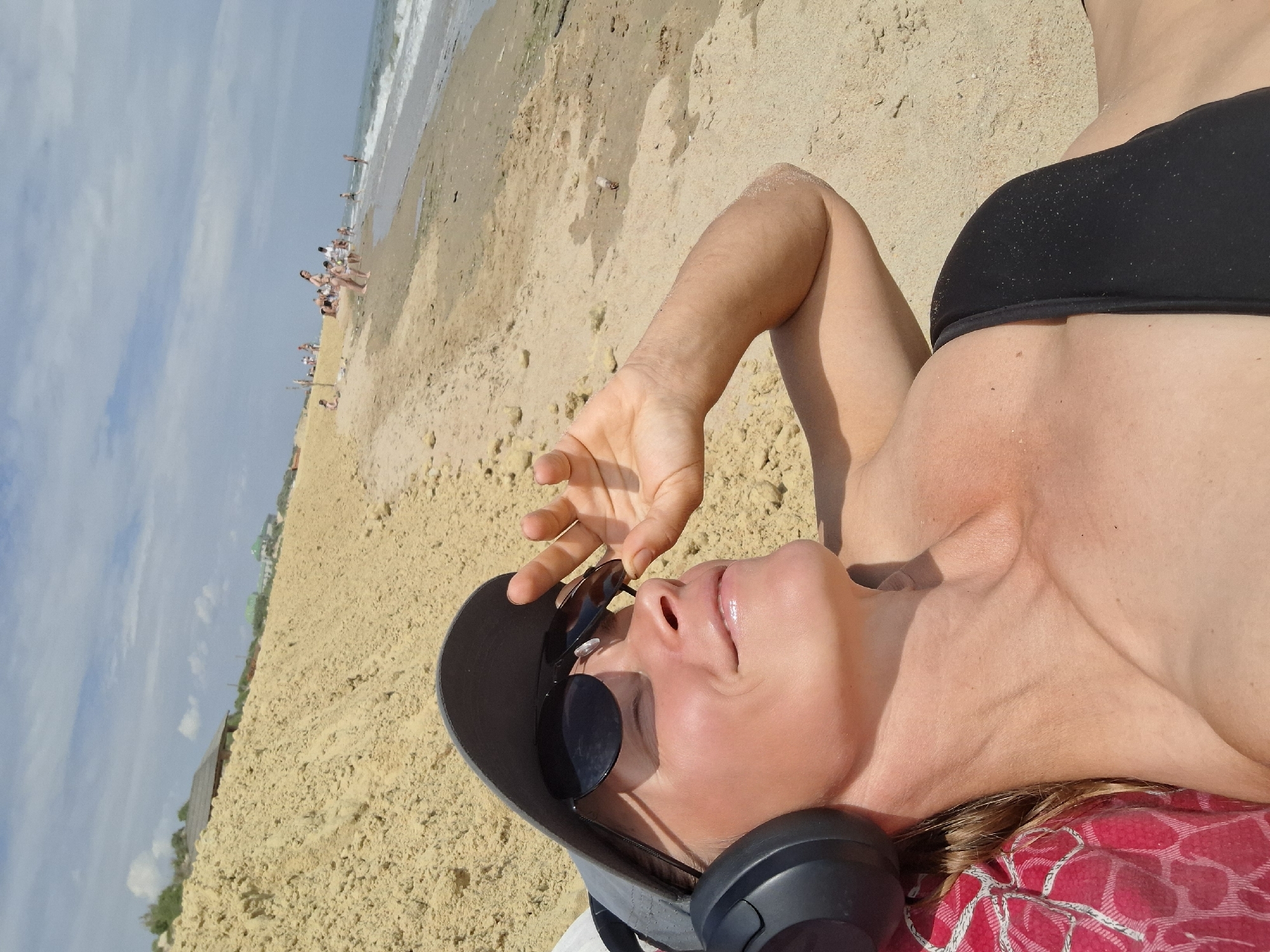 Relaxing on a sandy beach, looking out at the ocean.