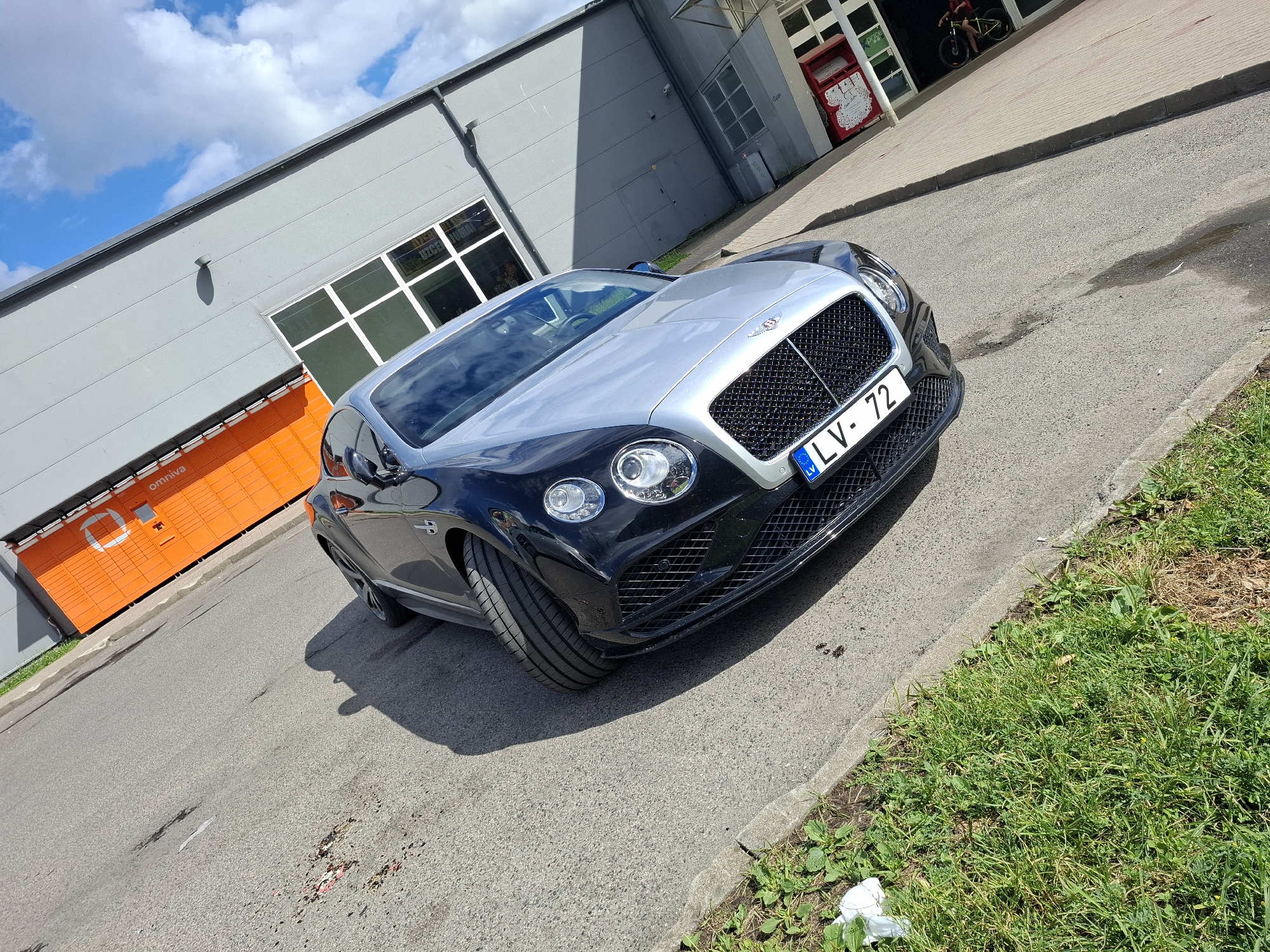 Bentley Continental GT parked outside Omniva branch in Riga