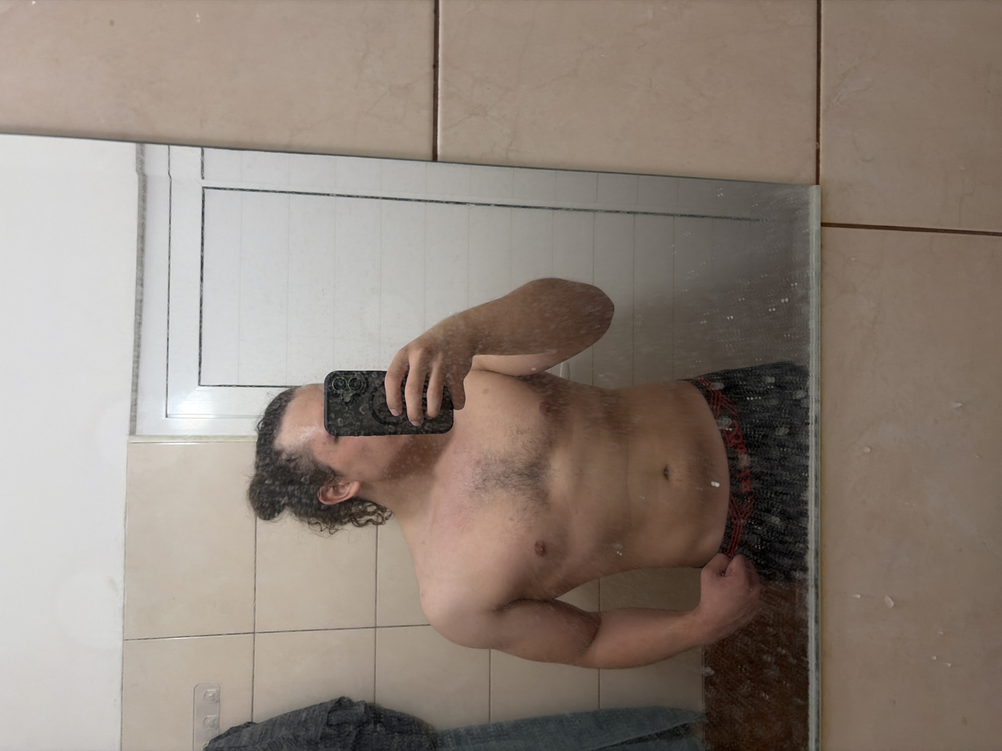 Person takes bathroom mirror selfies in Plovdiv, Bulgaria