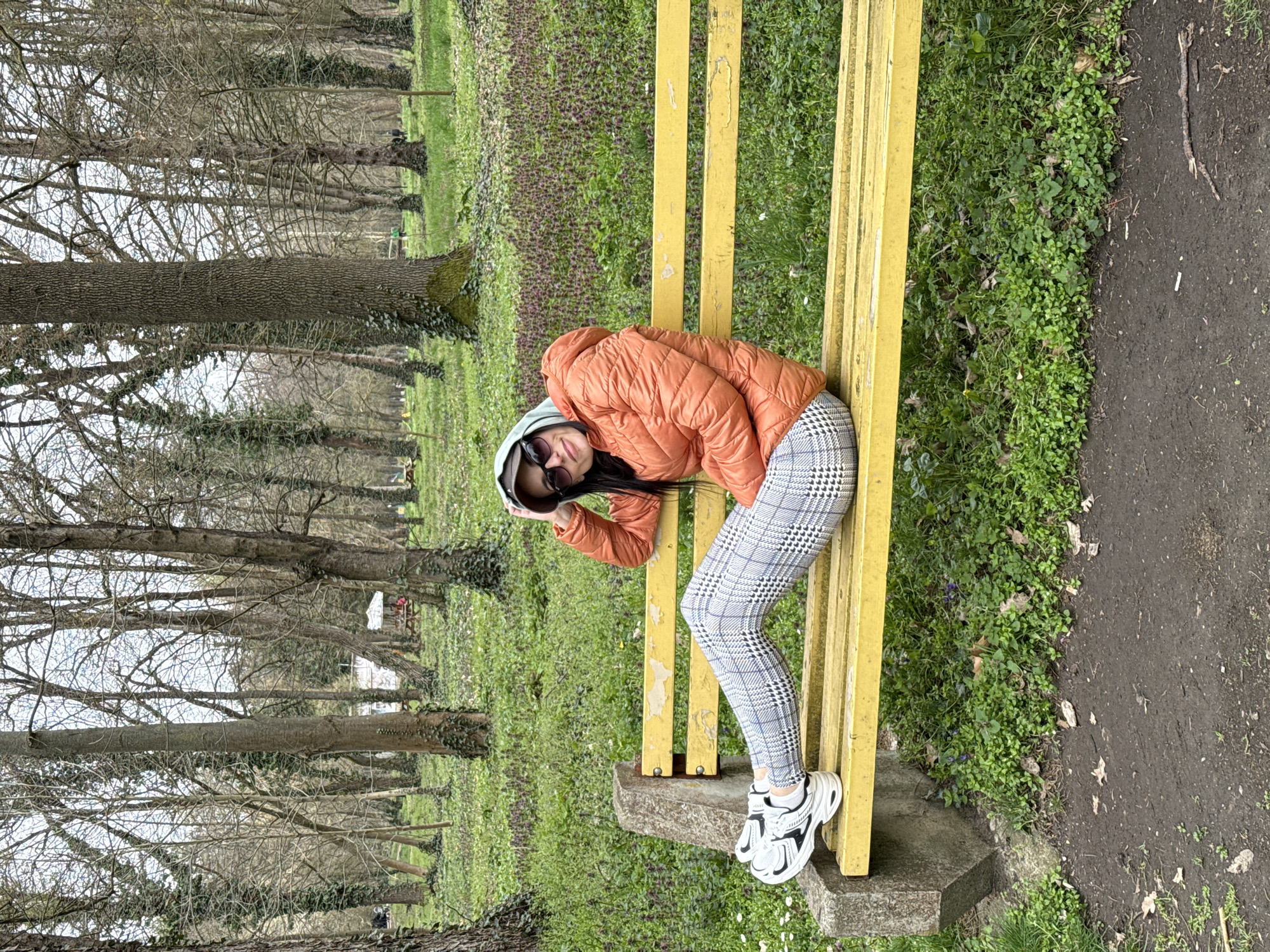 Woman relaxes on park bench in Pleven, Bulgaria