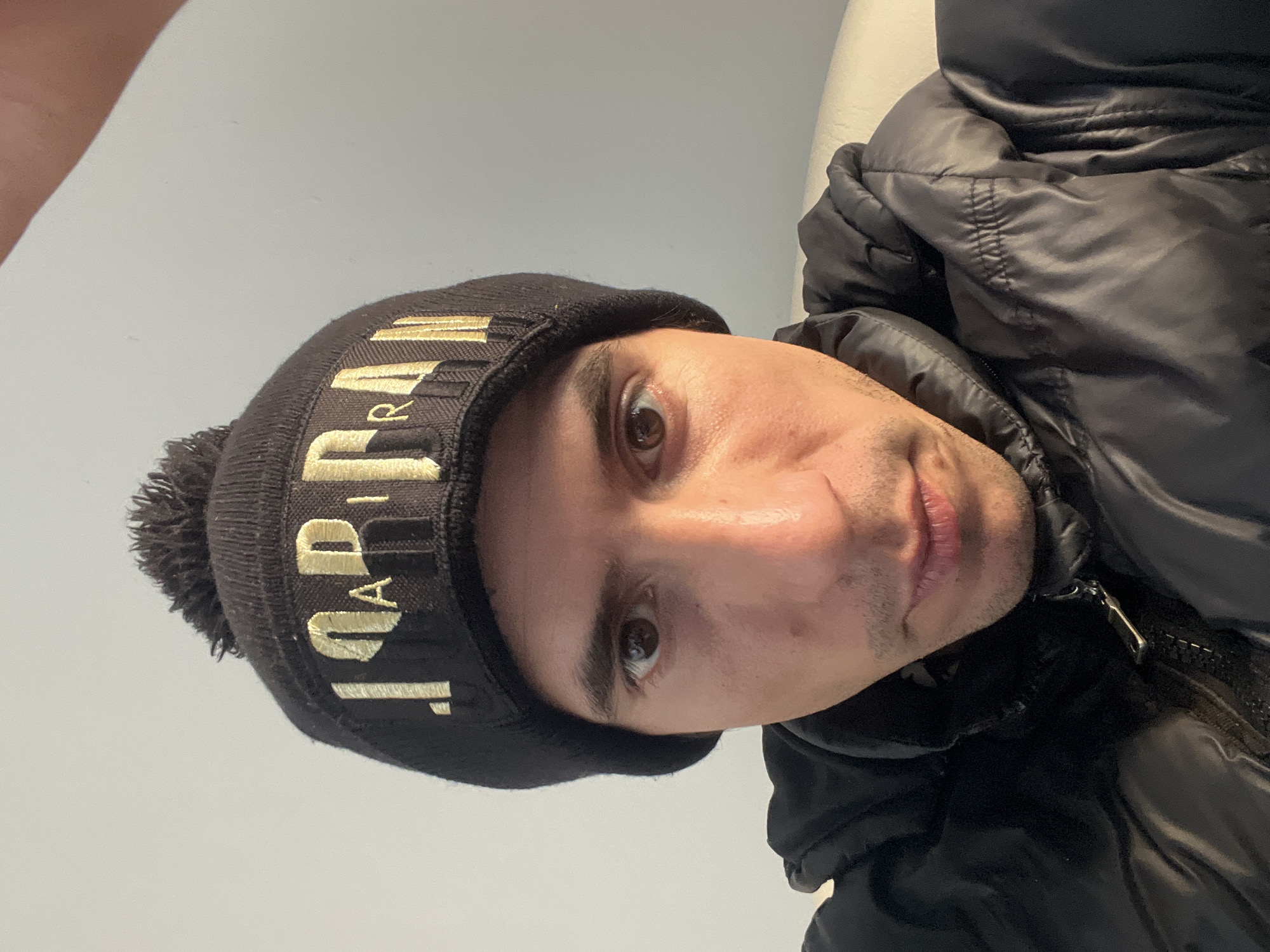 Man in Jordan beanie, black dog captured in Buenos Aires