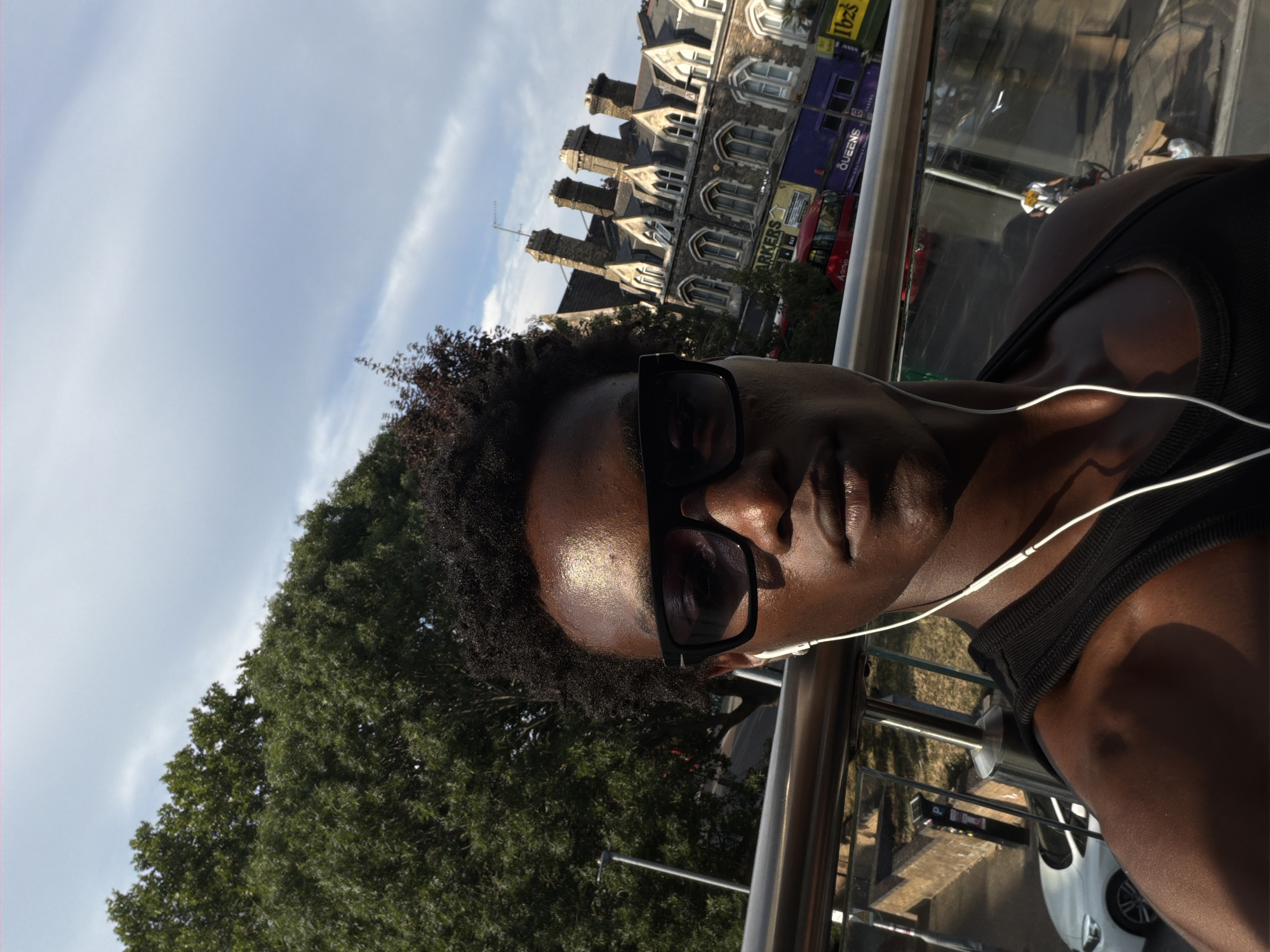 Summer selfie in South London, sunglasses and earbuds on