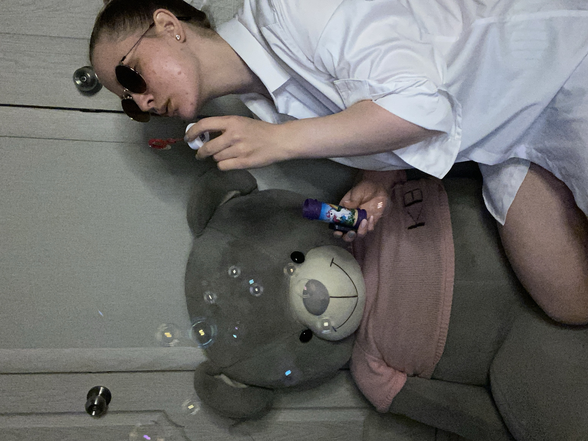 Young woman documents quiet afternoon routine with cat and snacks