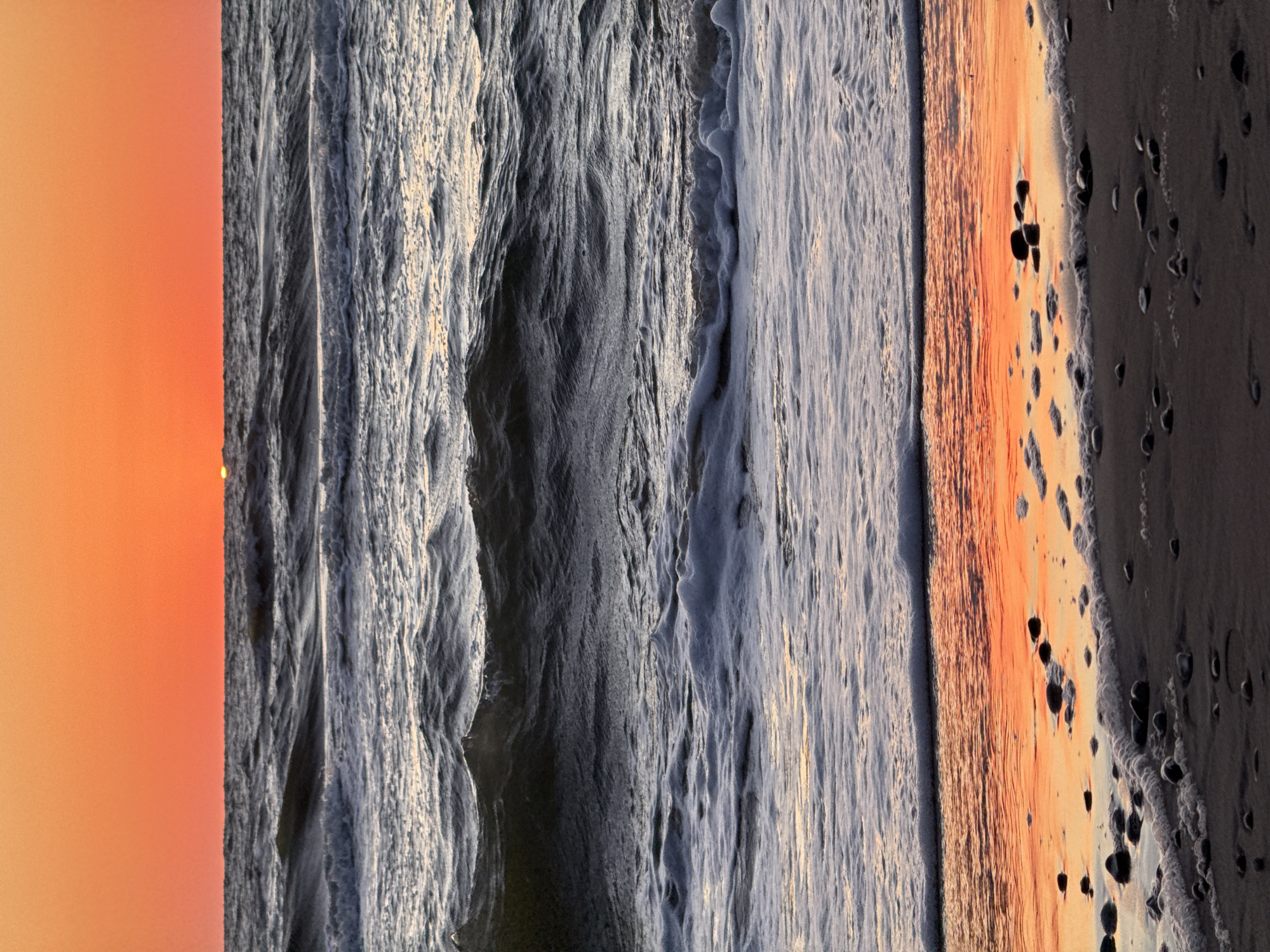 Baltic sunset burns orange over Ventspils shoreline
