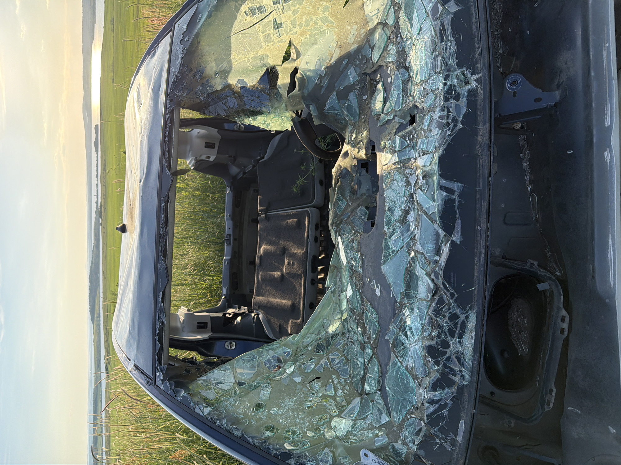 Damaged car wreck documented in field near Tvarditsa, Bulgaria