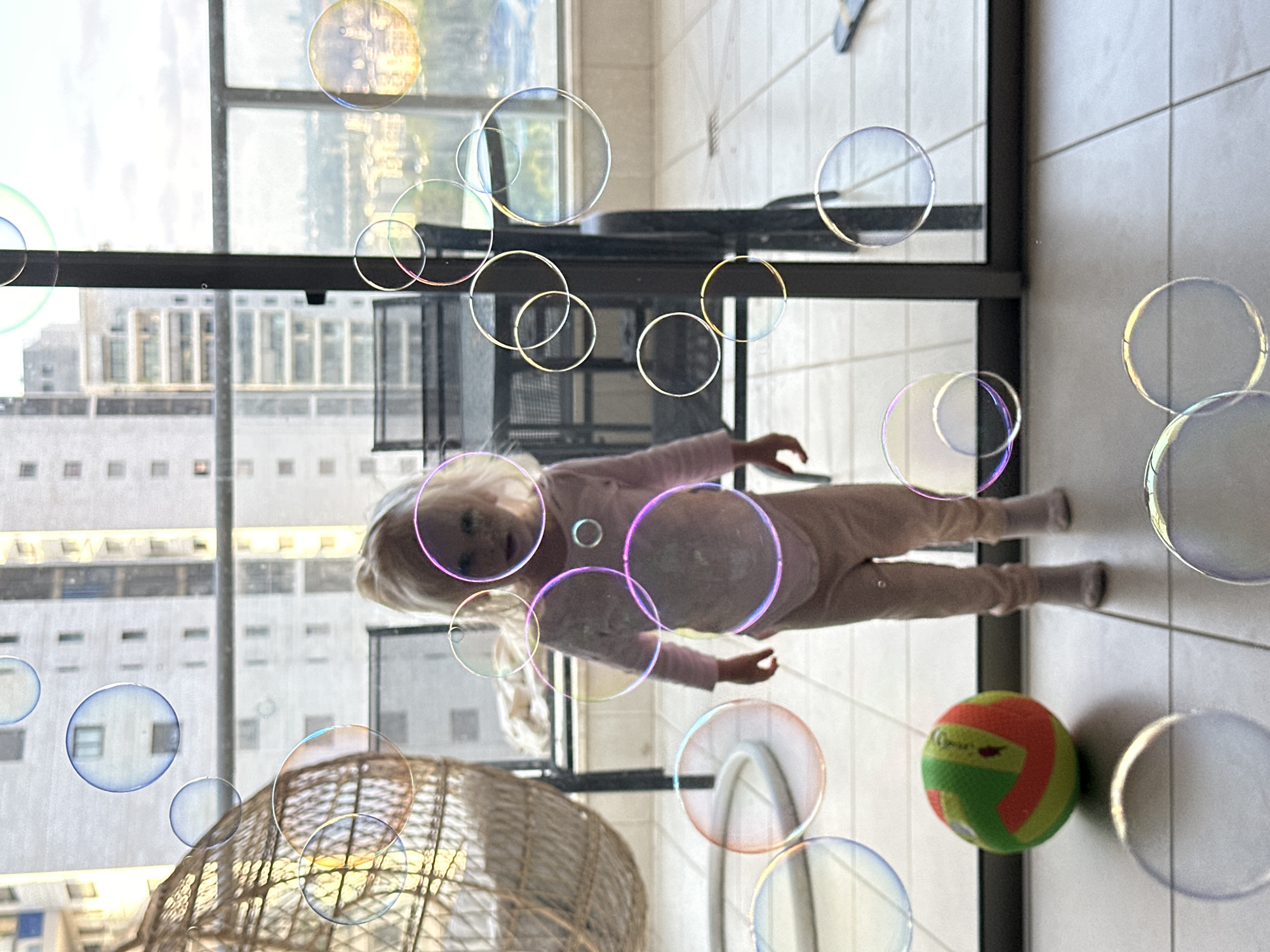 Bubble play on a Petah Tikva apartment balcony afternoon