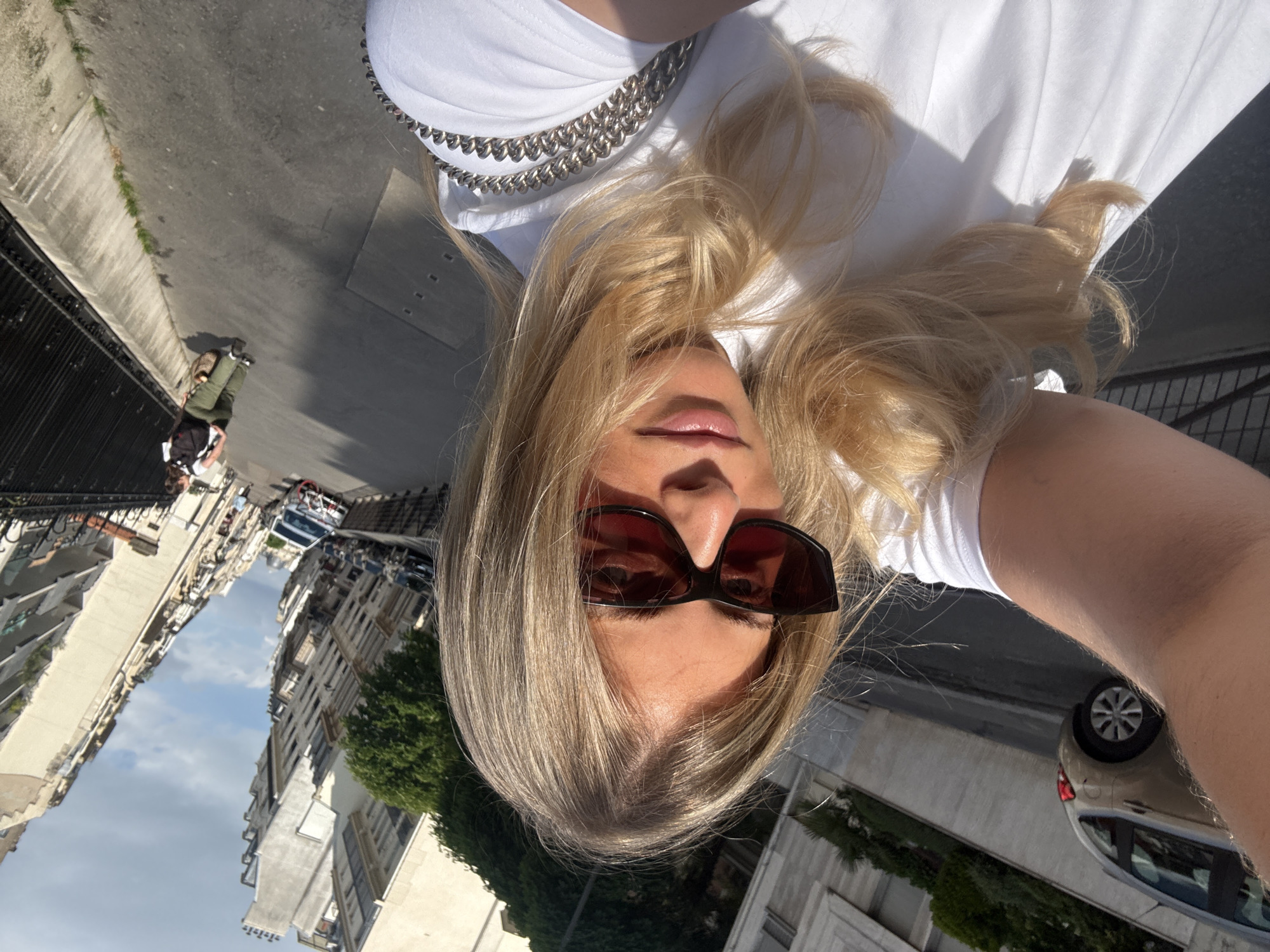 Blonde woman in sunglasses photographed multiple times in Paris