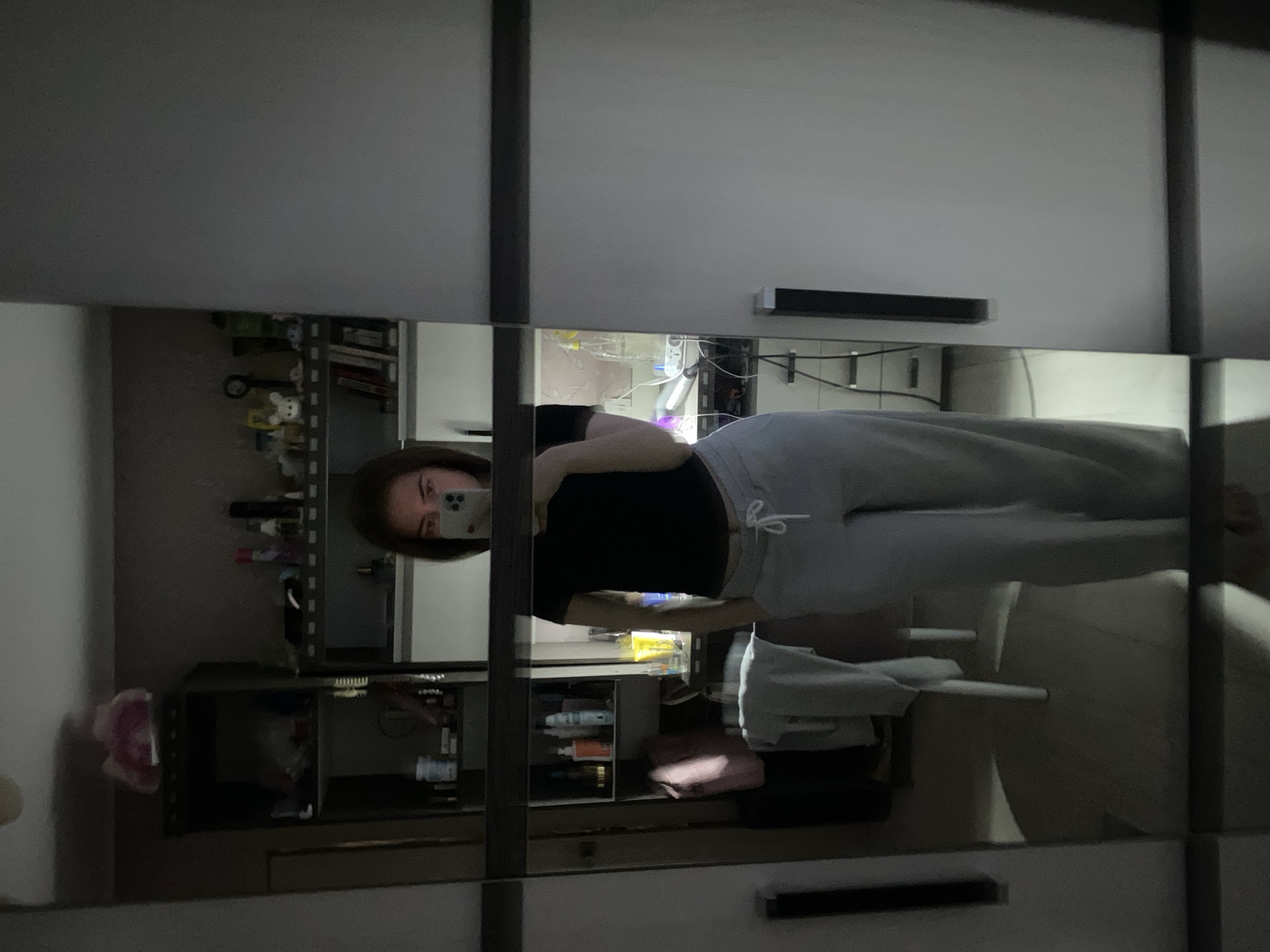 Young woman documents bathroom routine in mirror selfies