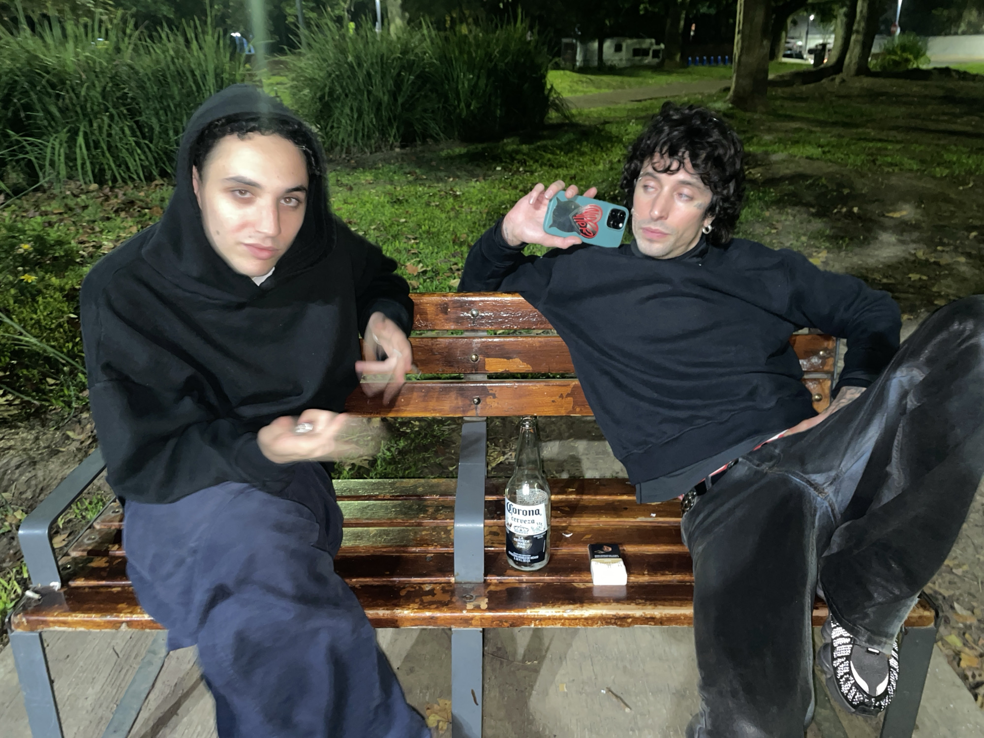 Two men sit on bench in Buenos Aires early morning