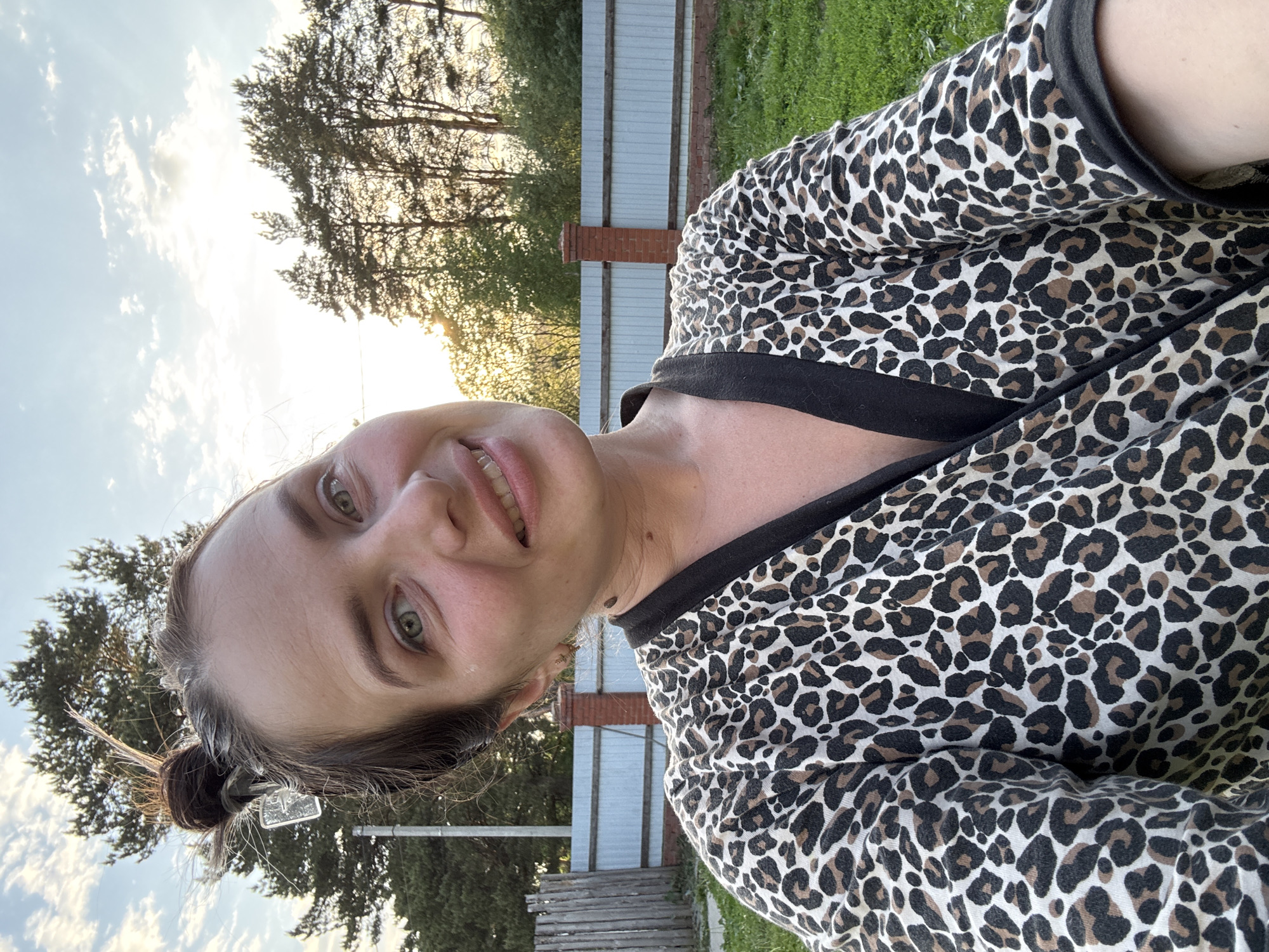 Woman takes selfies with dog in Russian village garden