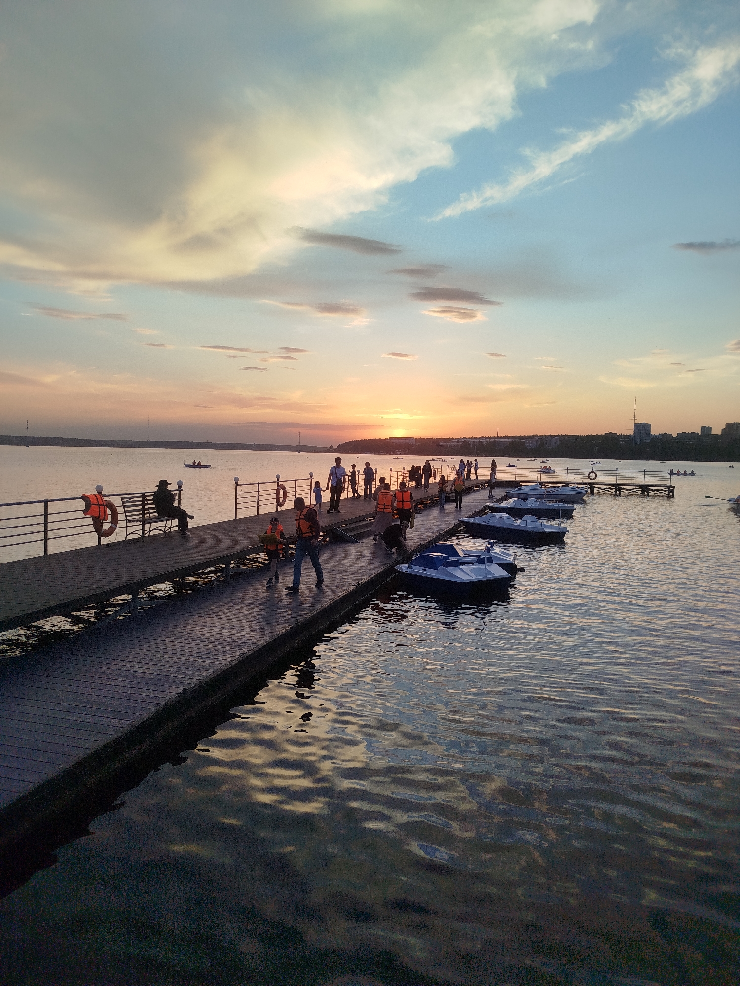 Evening waterfront activities documented during Izhevsk sunset scenes