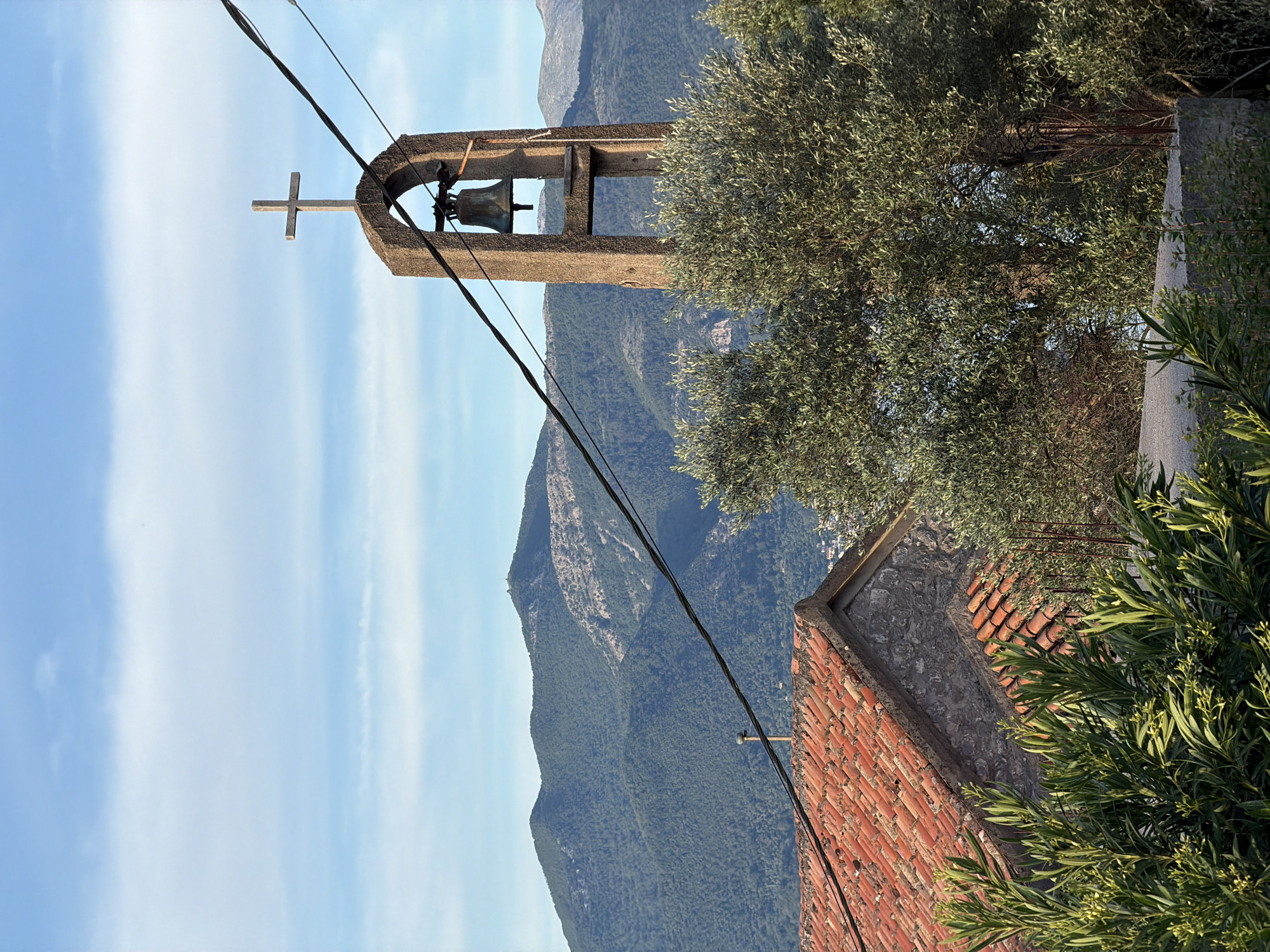 Village walk captures spring blooms, bell tower, cat in Montenegro