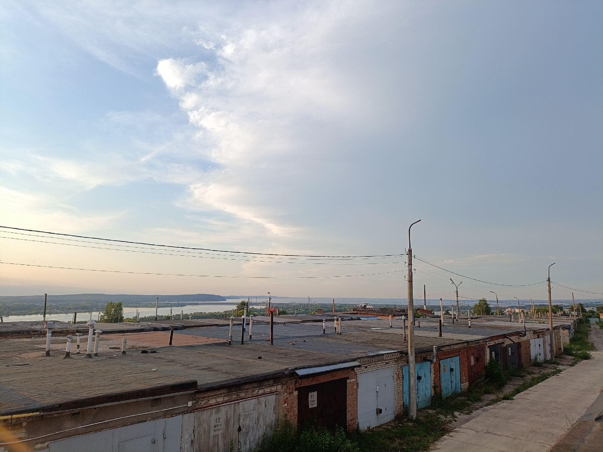 Garage row and overgrown lot on Chaikovsky's industrial fringe