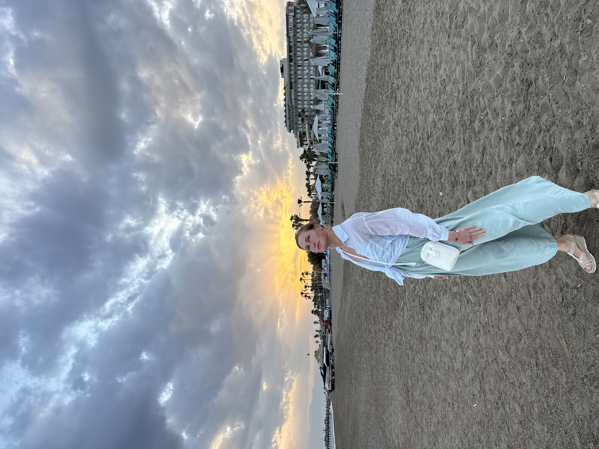 Woman poses for sunset photos on Serik beach