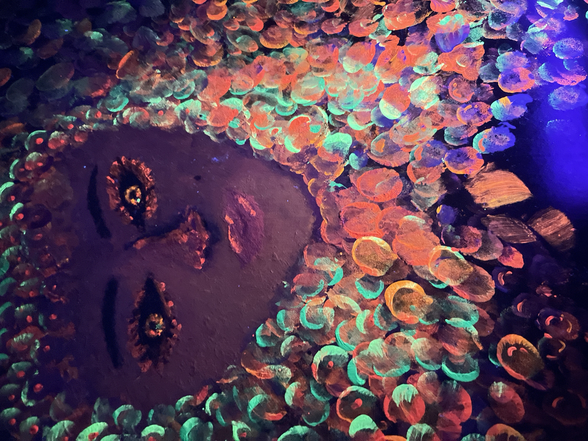Woman drinks orange beverage near glowing artwork in Chaikovsky