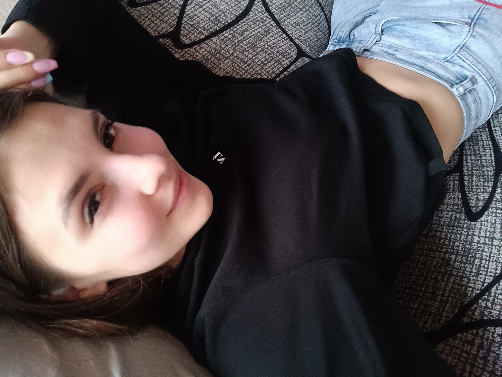 Woman takes selfies on couch in Chaikovsky