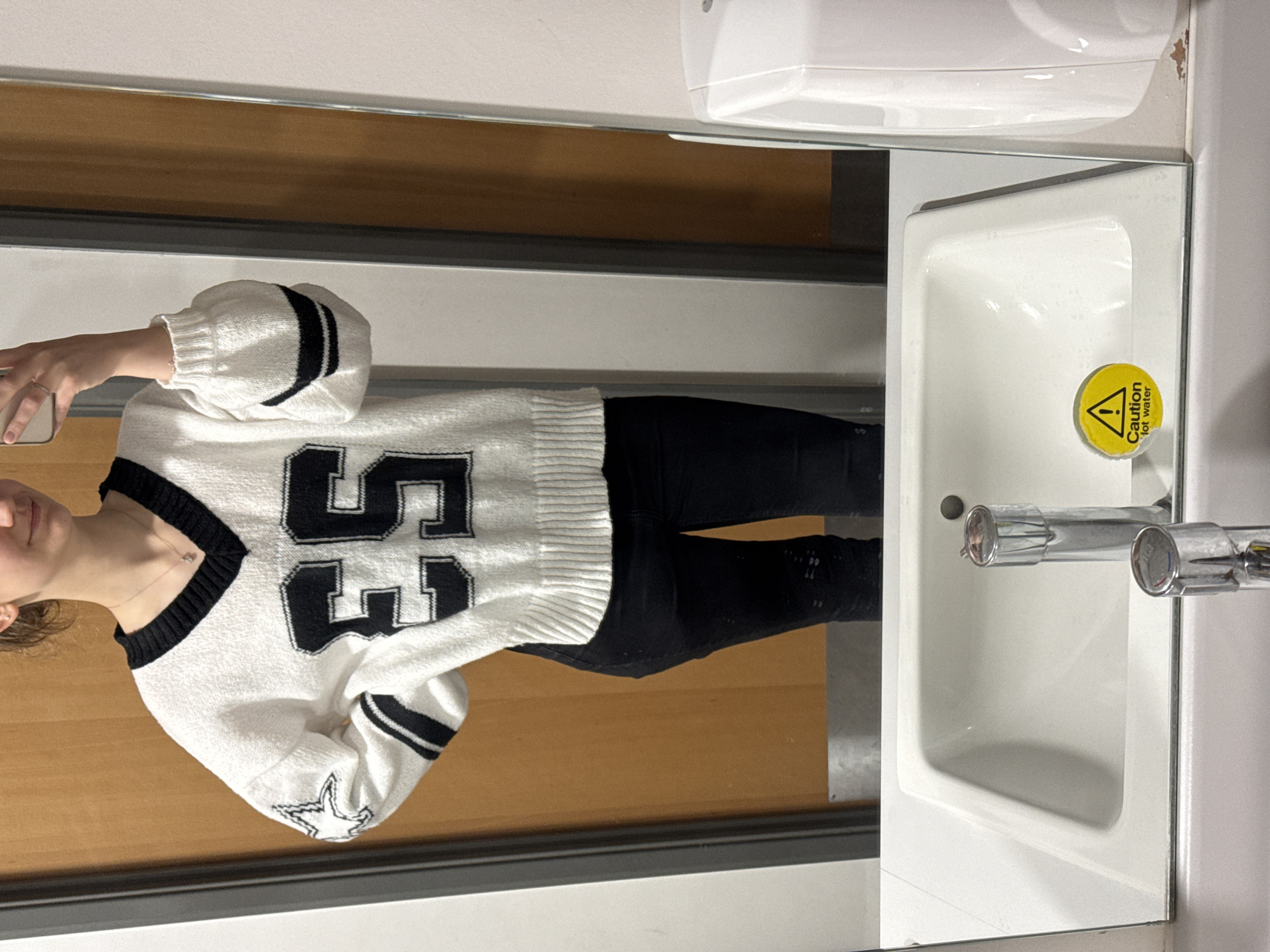 Mirror reflection captured in Ipswich bathroom showing numbered sweater