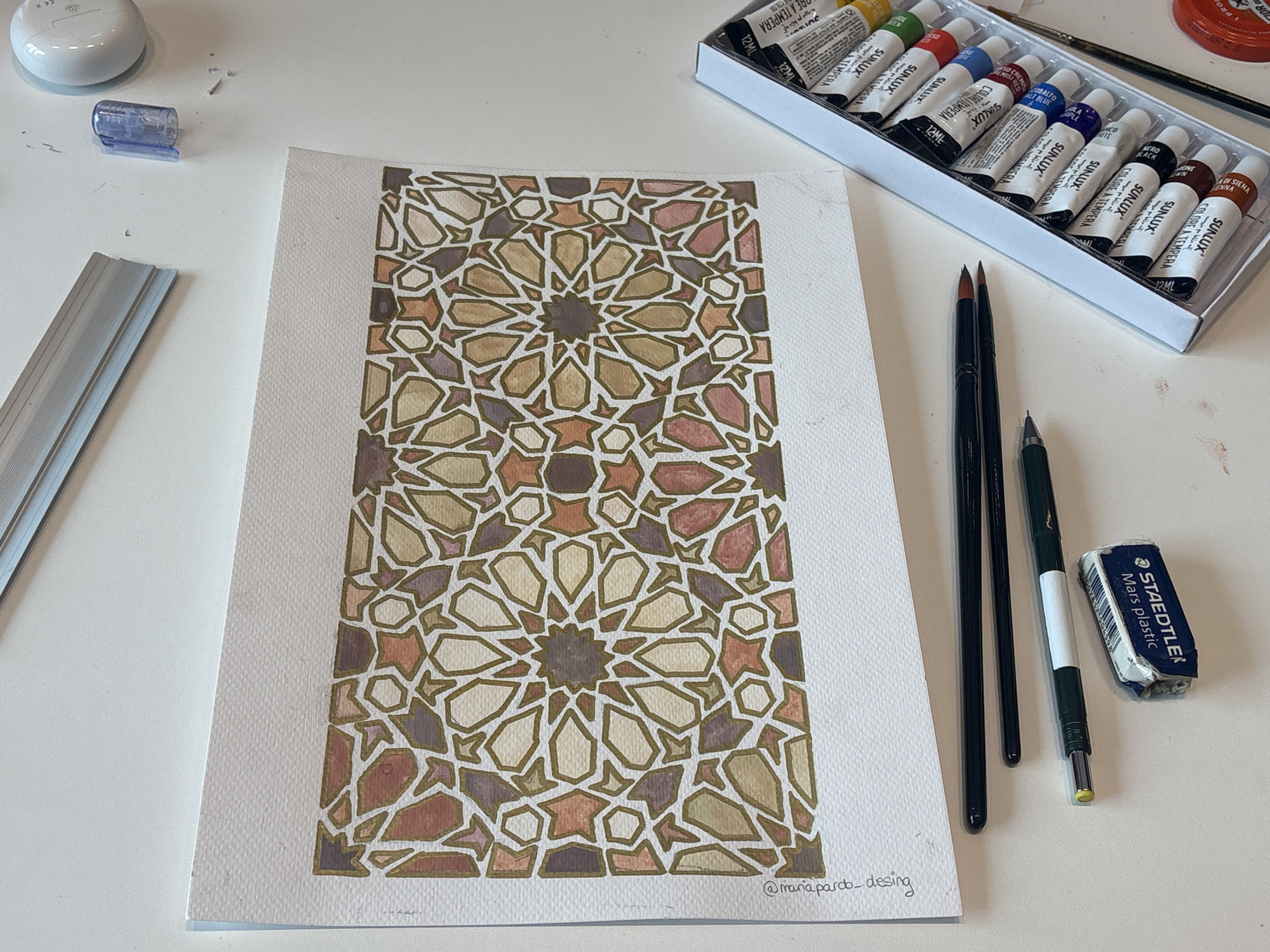 Artist creates geometric watercolor painting in Milan workspace