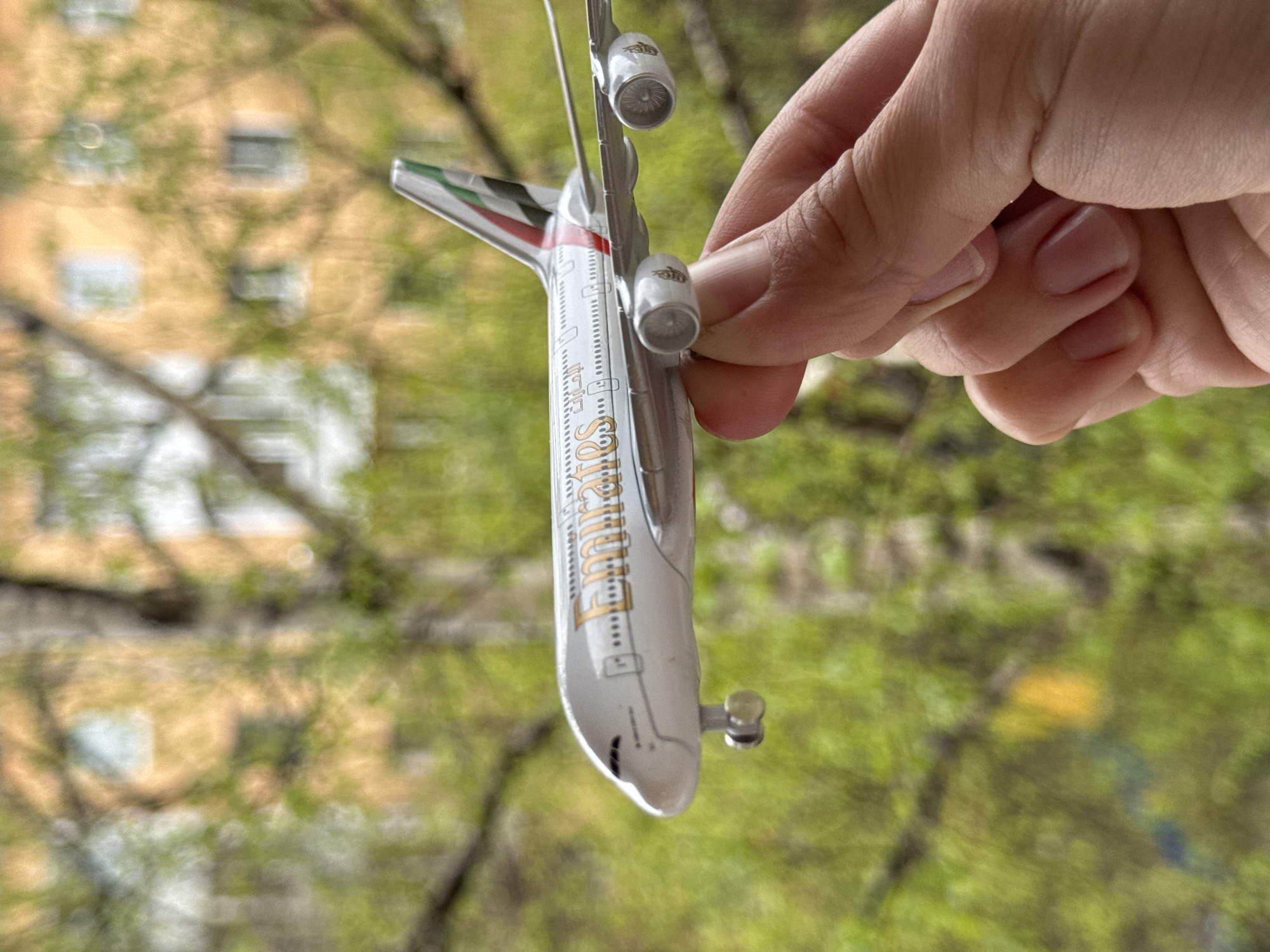 Toy Emirates airplane held in hand in Irkutsk