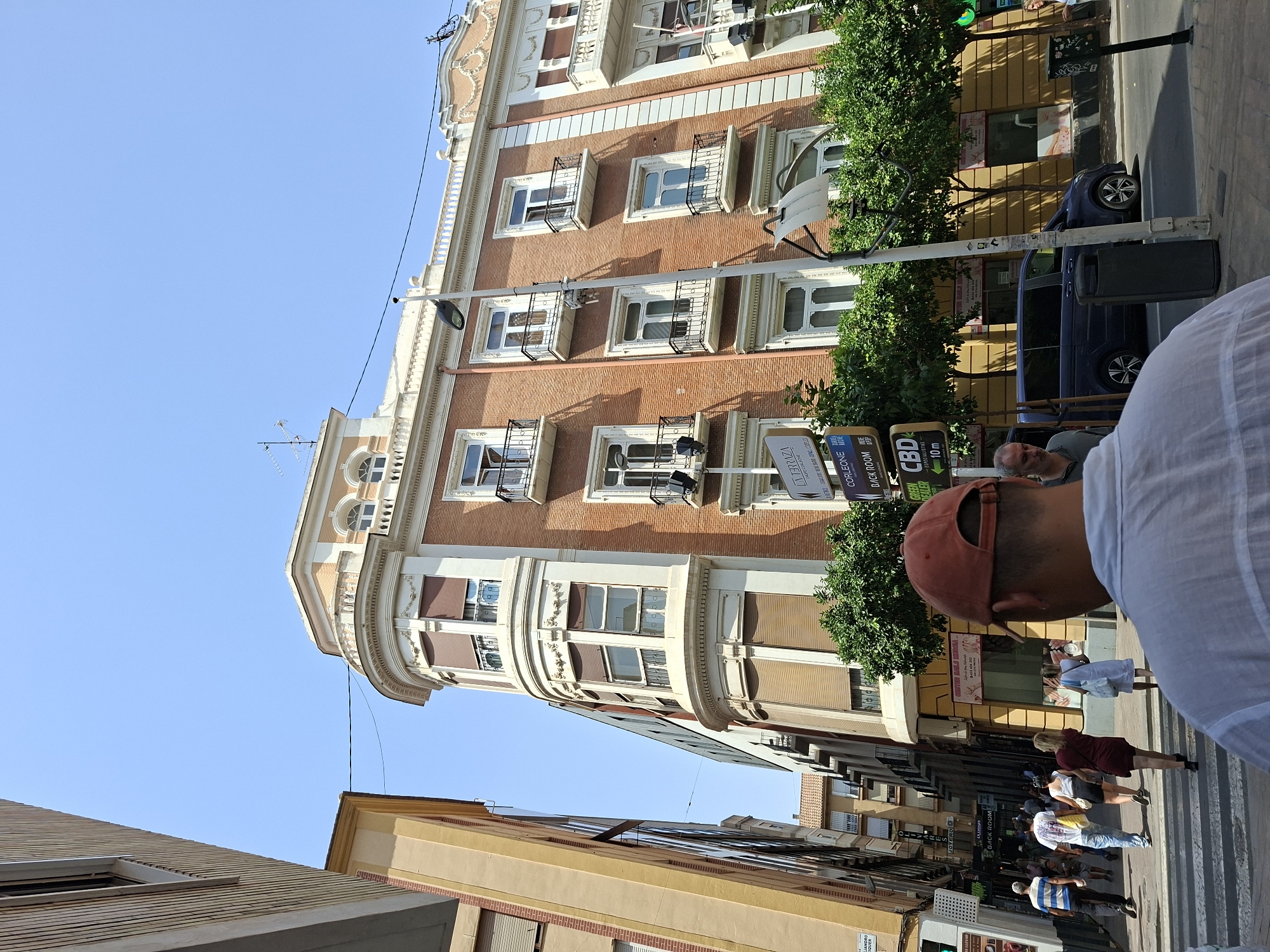 Grand curved facade anchors a busy Murcia street scene