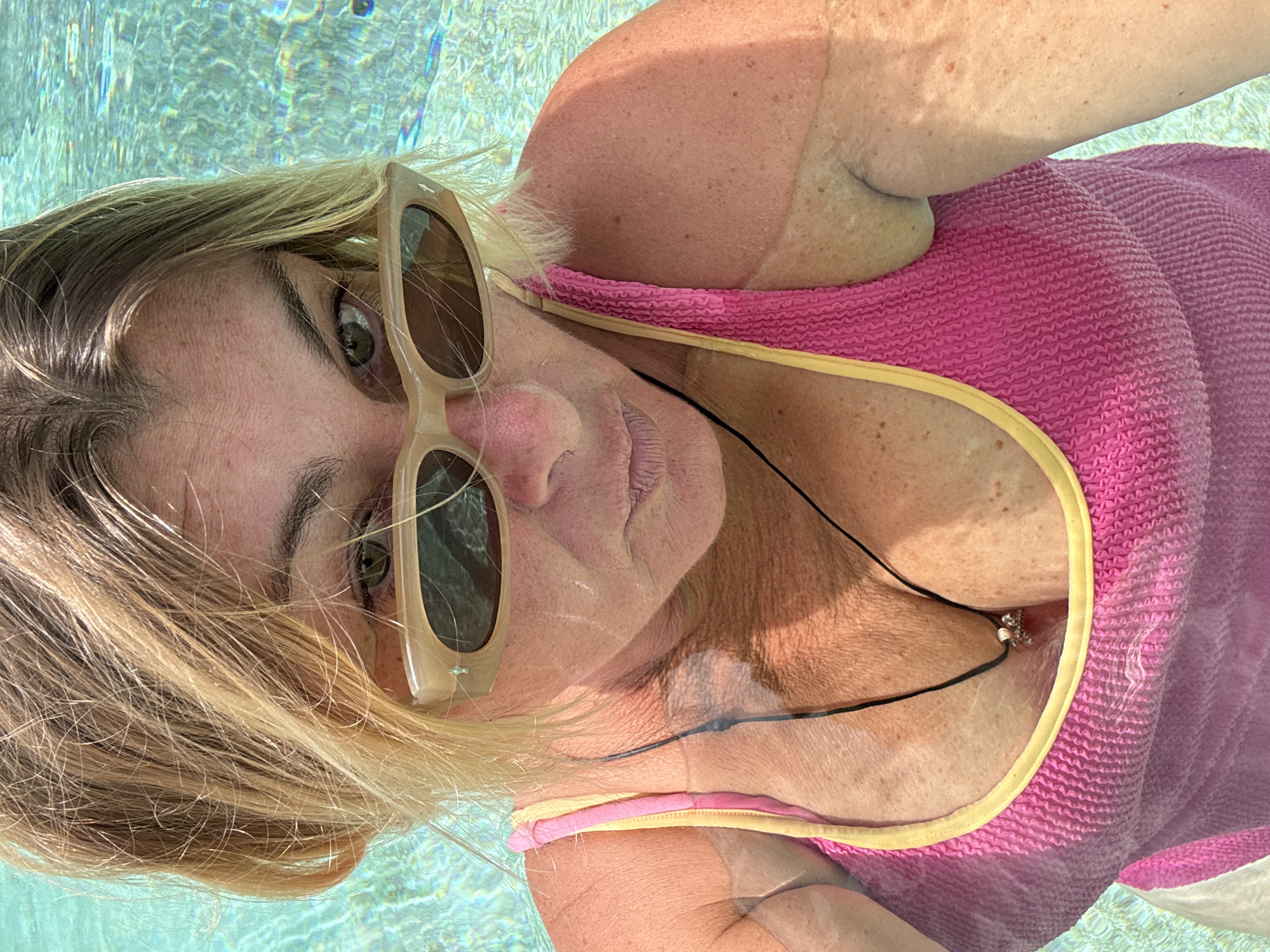 Poolside relaxation with palm tree skies and turquoise water