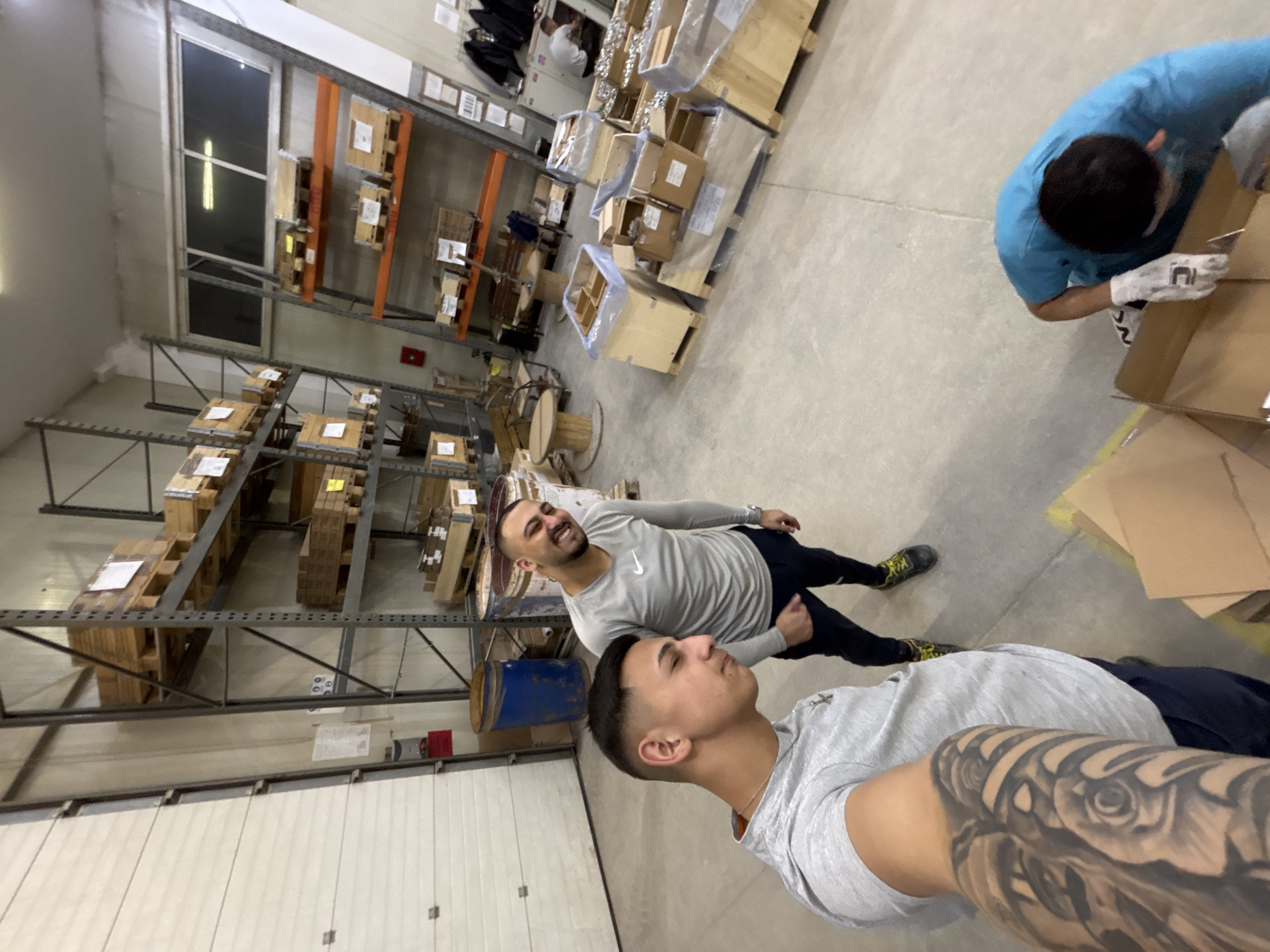Workers pack items in warehouse during evening shift