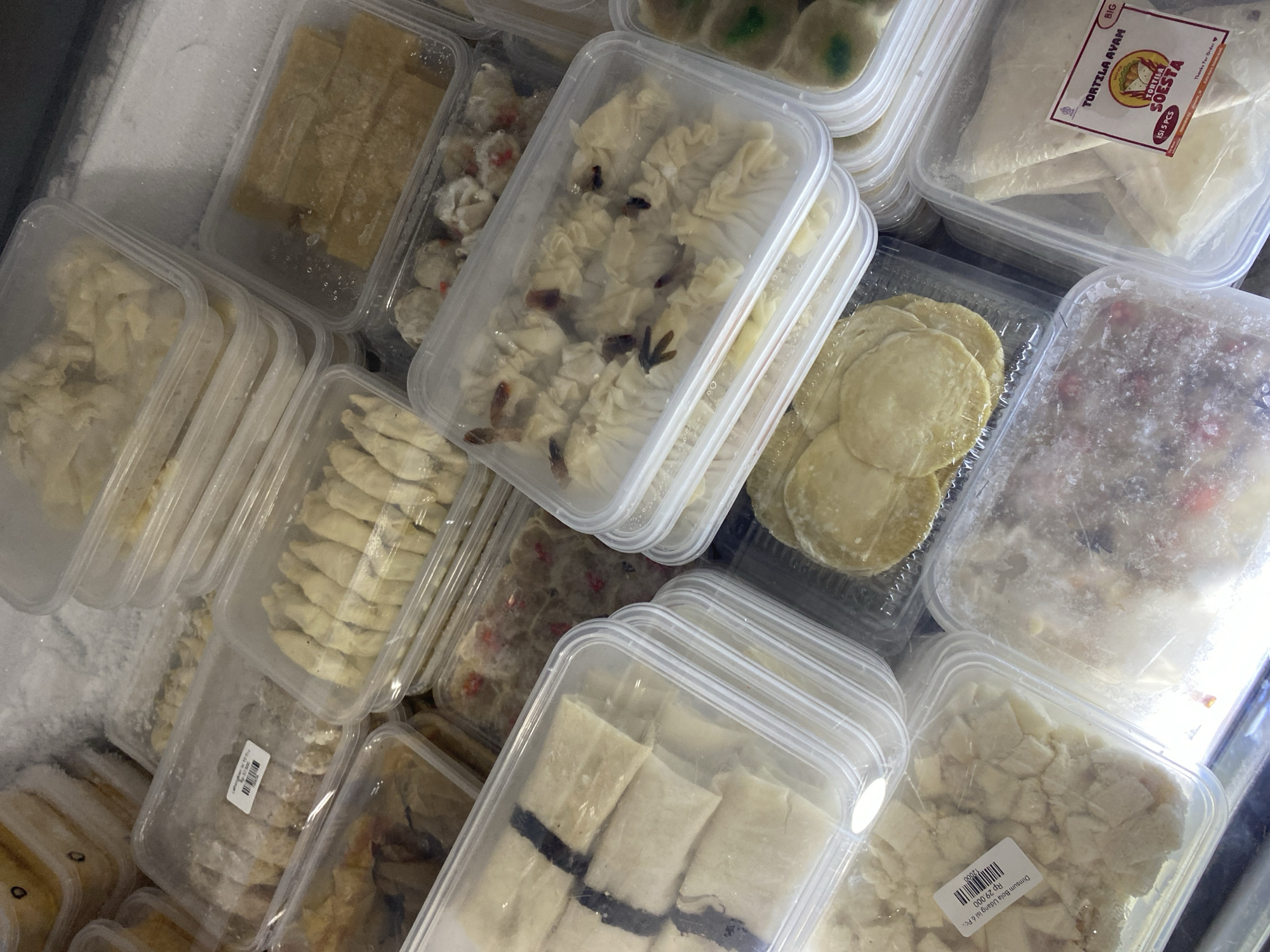 Freezer stocked with assorted packaged frozen baked goods