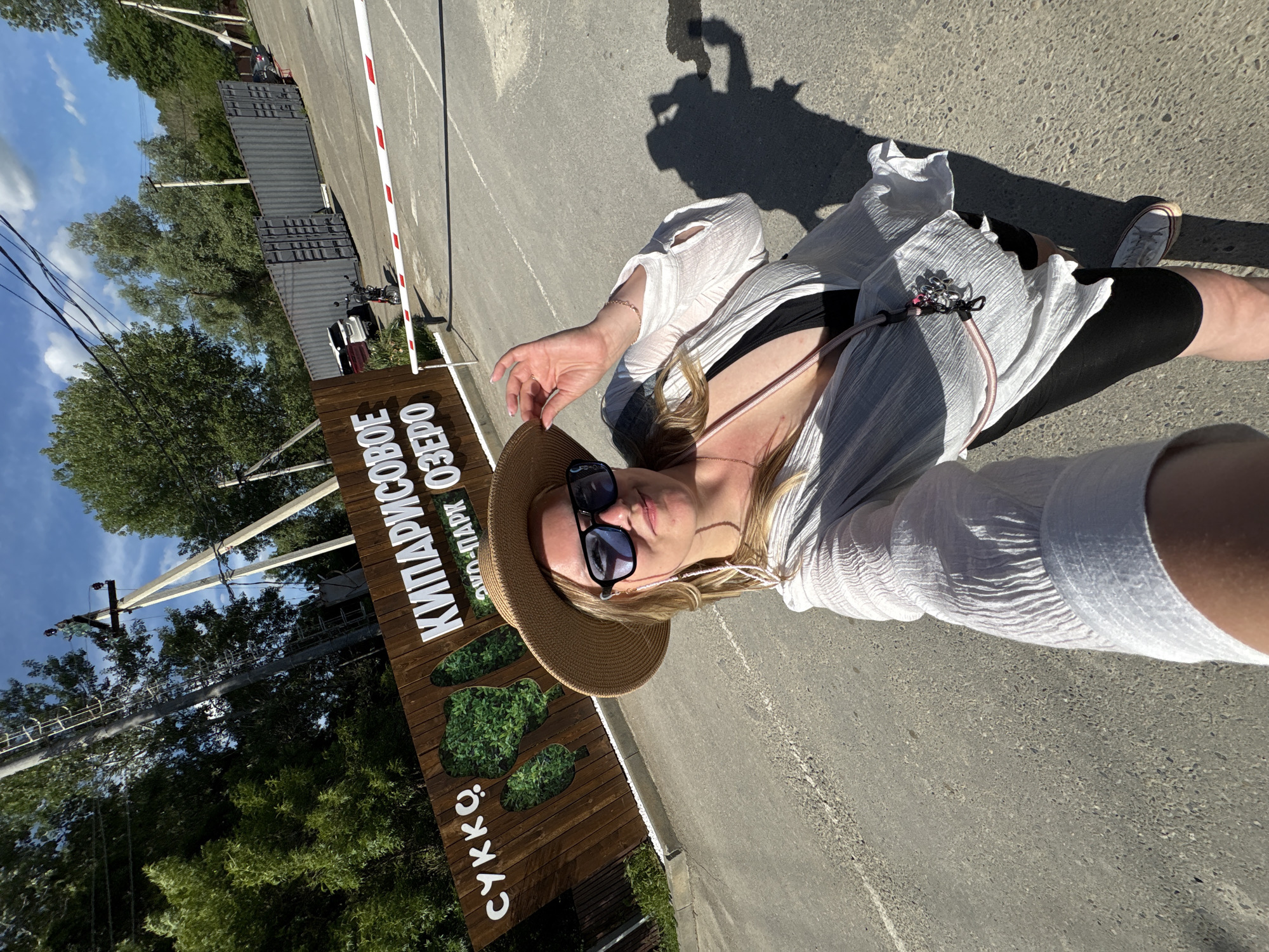 Women take sunny outdoor selfies at checkpoint entrance