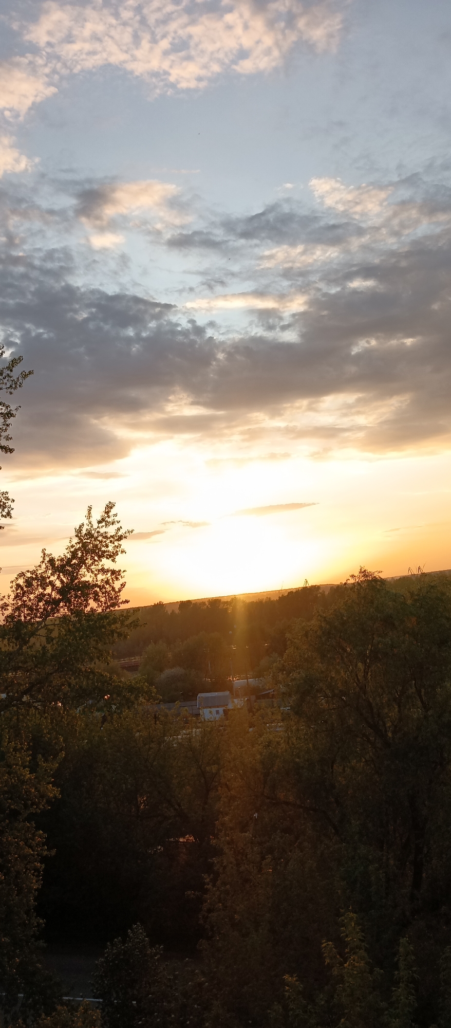 Witness documents sunset over unknown city from elevated vantage