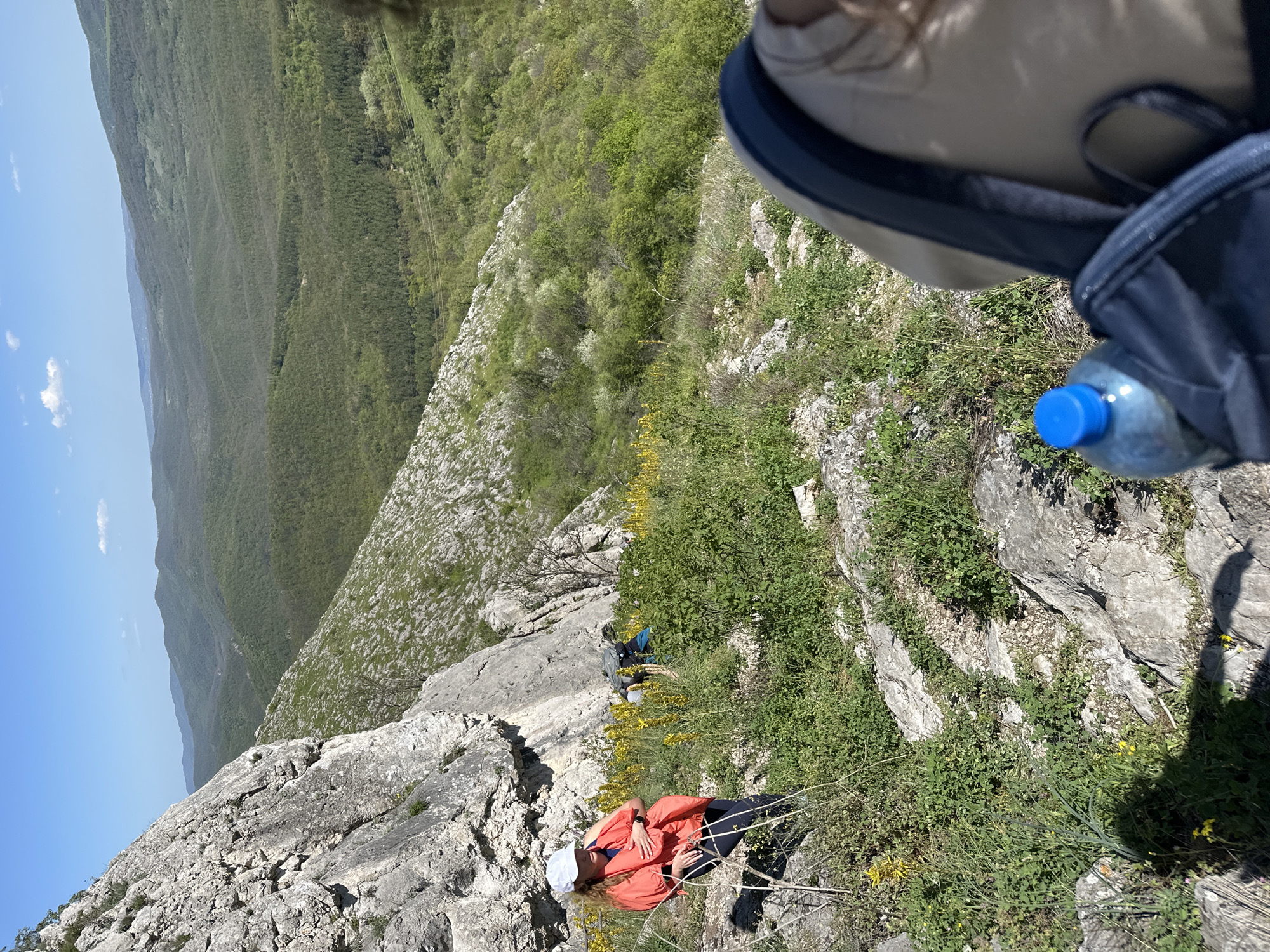 Climber rests on rocky hillside near Bilka, Bulgaria