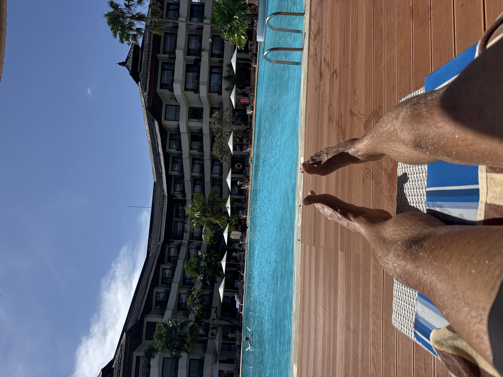 Tourist captures morning poolside moments at Denpasar resort