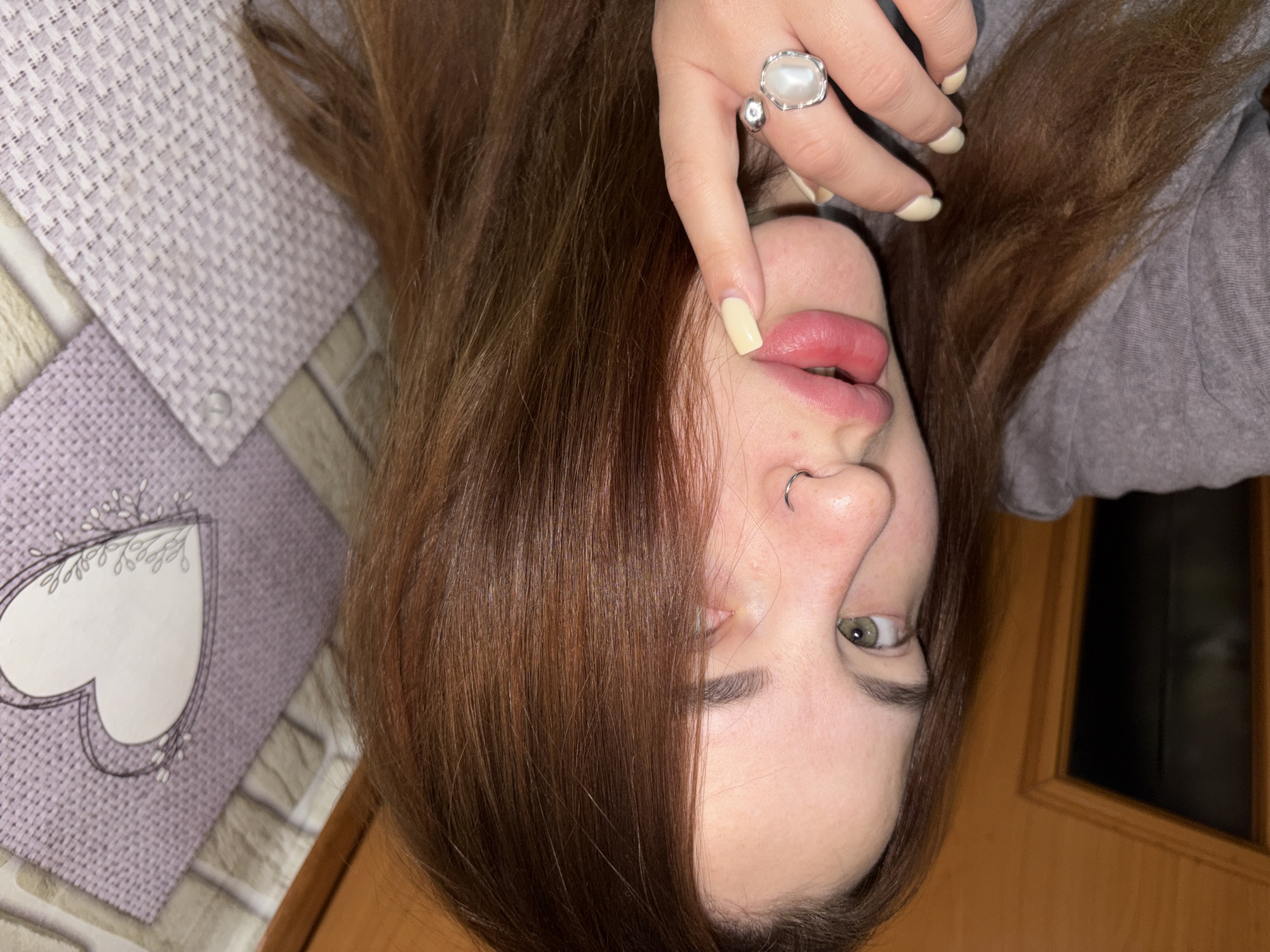 Person with green eyes photographed lying down, looking at camera