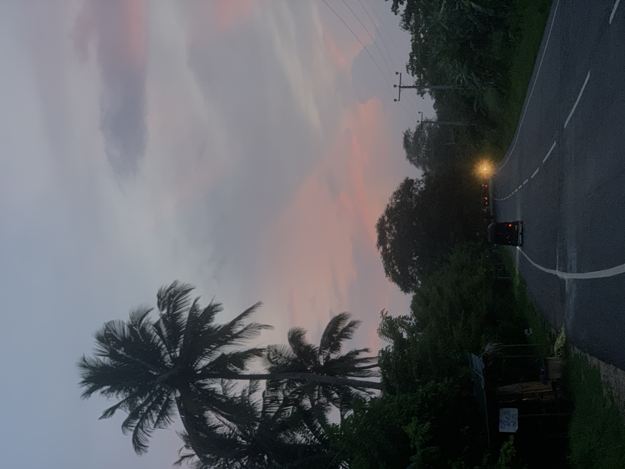 Vehicle travels scenic sunset road in Batawala, Sri Lanka