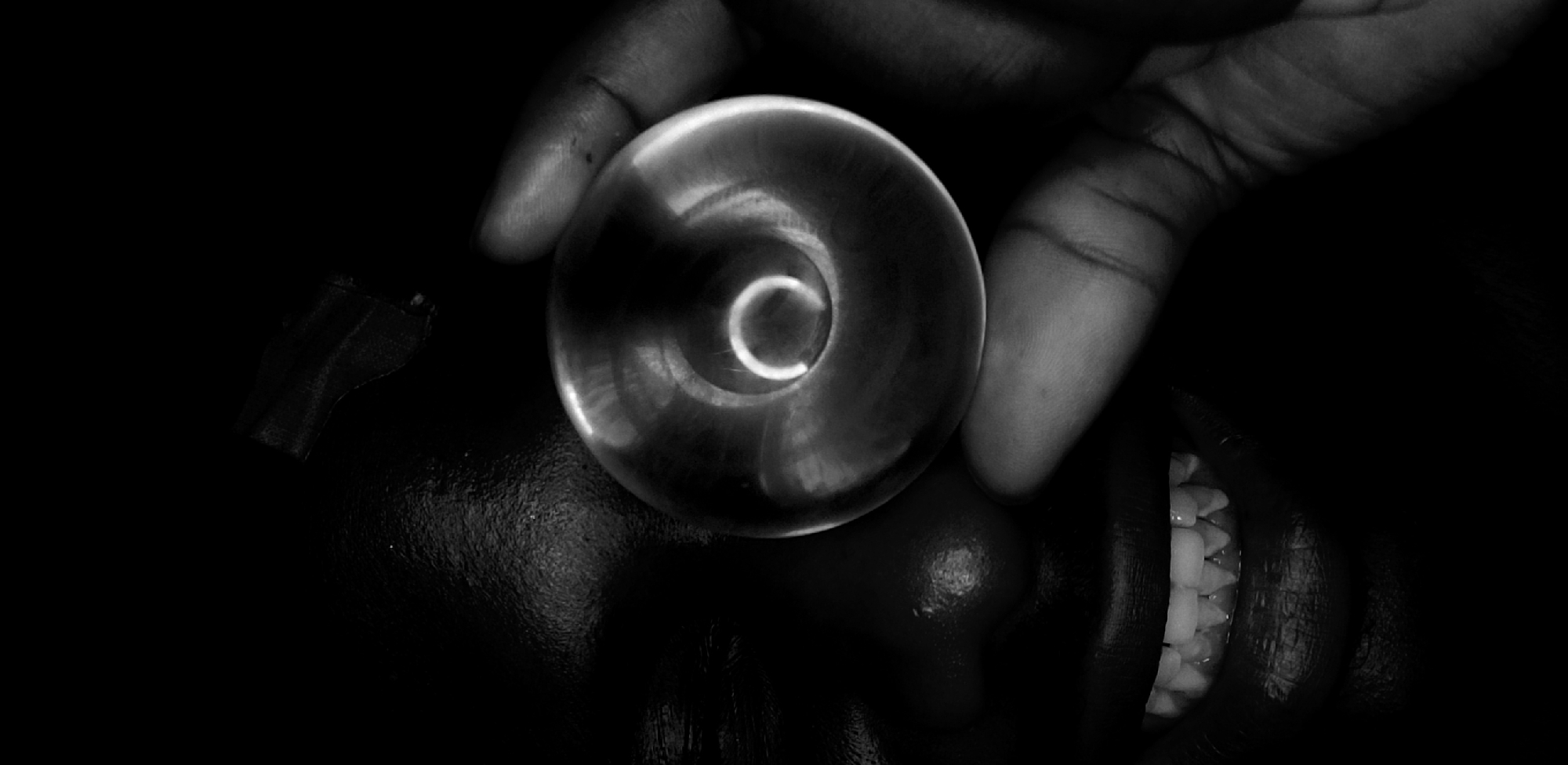 Artistic portrait session with transparent sphere captured in Nigeria