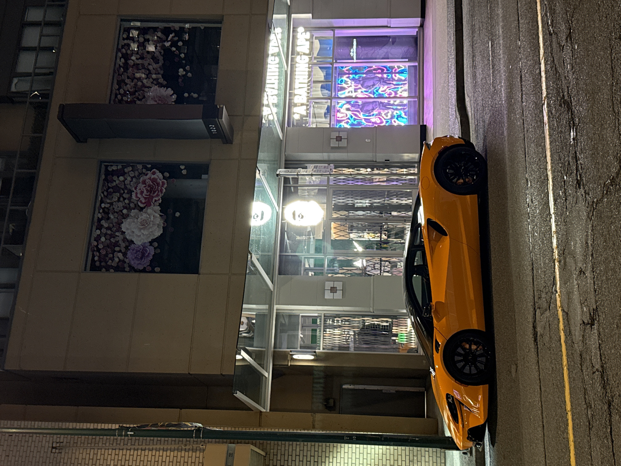 Orange McLaren parked outside FIFA-themed Adidas store, downtown Vancouver