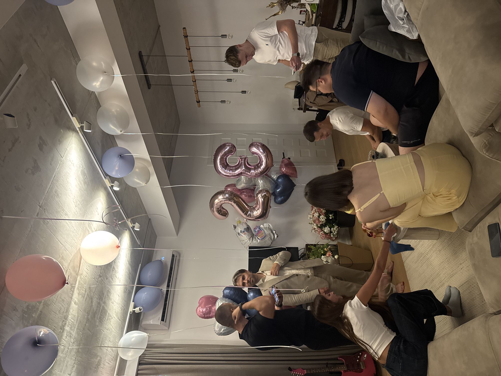 Birthday gathering in a modern Tbilisi apartment, July evening