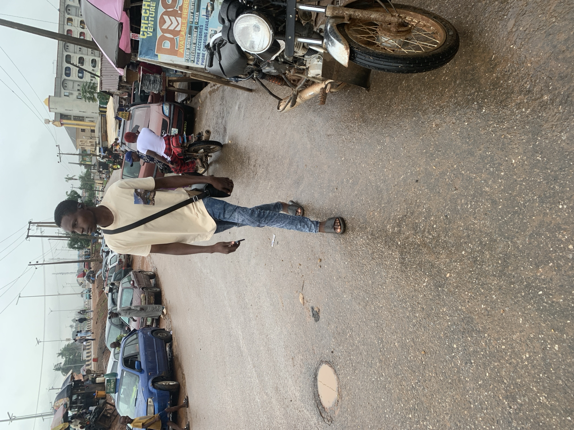 Wet afternoon street life near Shagamu's market district