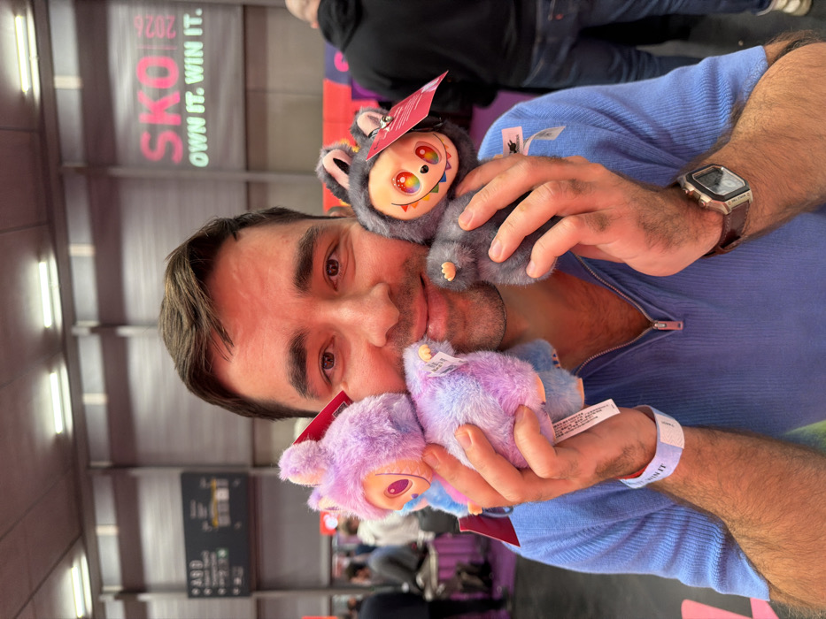 Man holds plush toys near promotional banner in Vienna