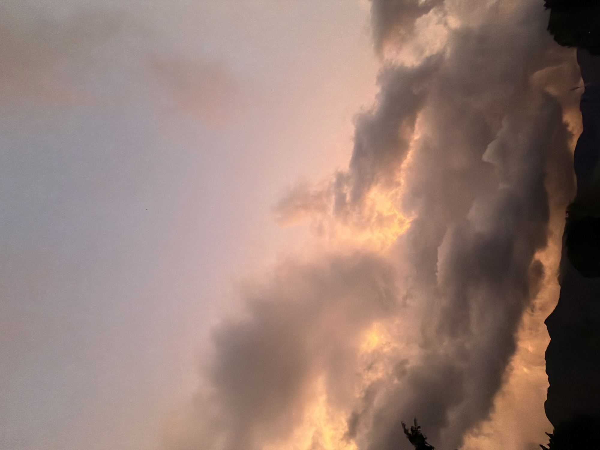 Dramatic sunset colors illuminate cloudy skies over El Cambur, Venezuela
